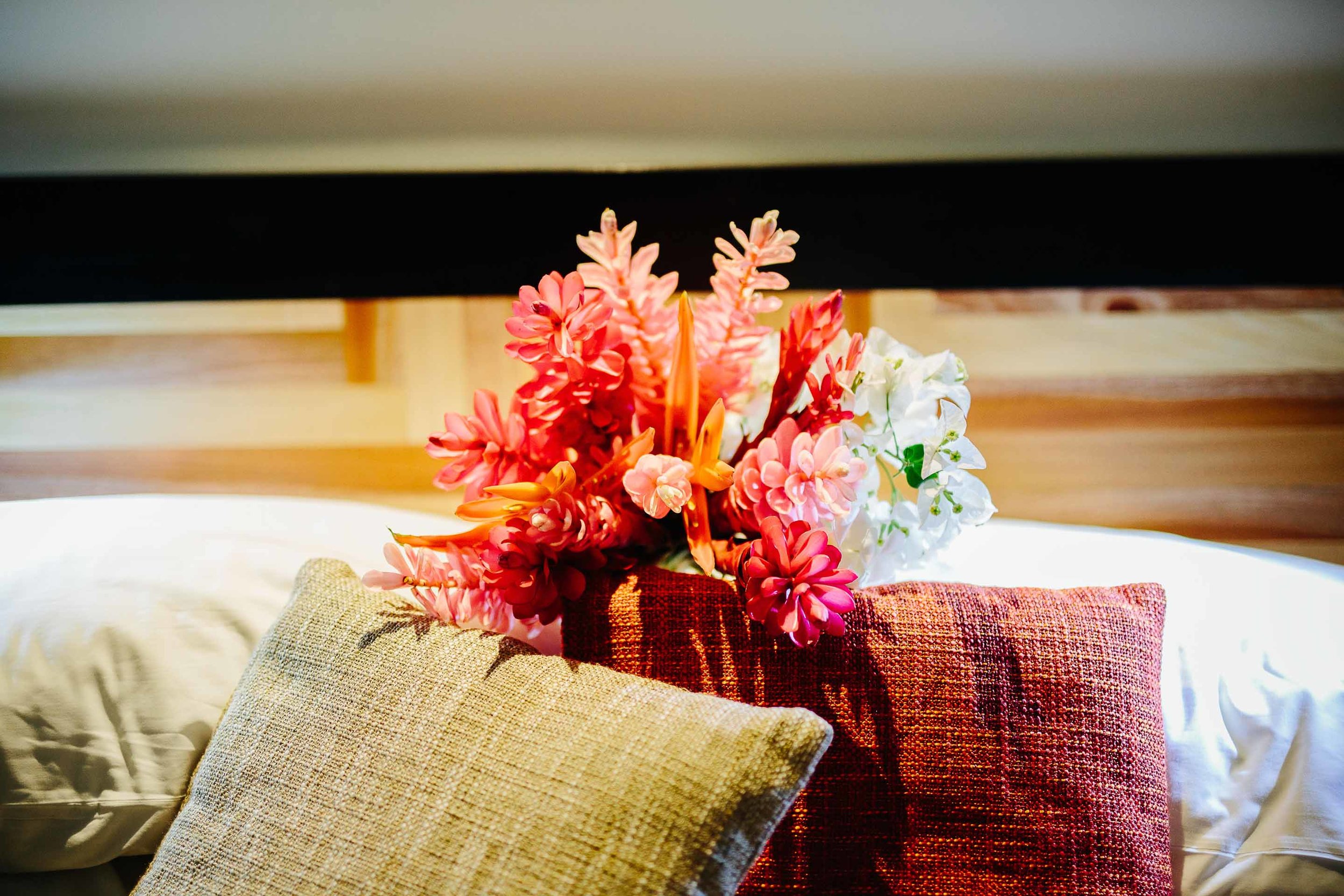 Bridal bouquet resting on pillows