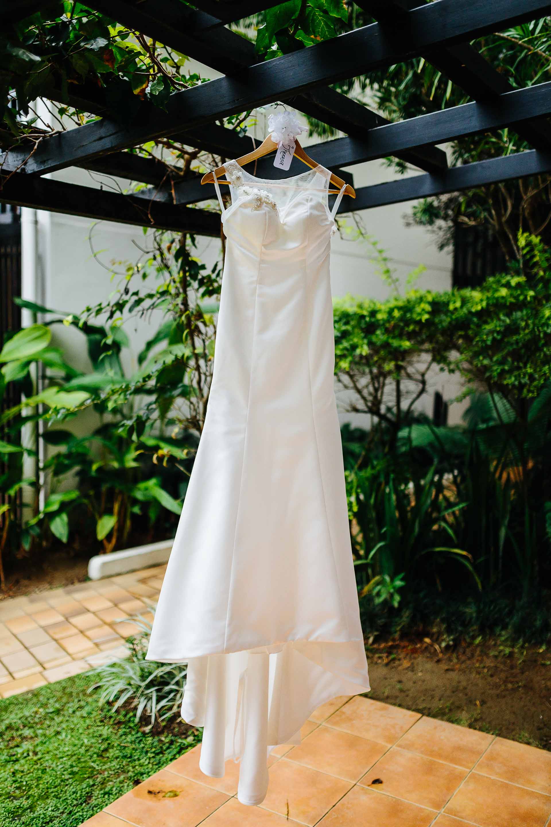 wedding dress hanging from hotel room veranda