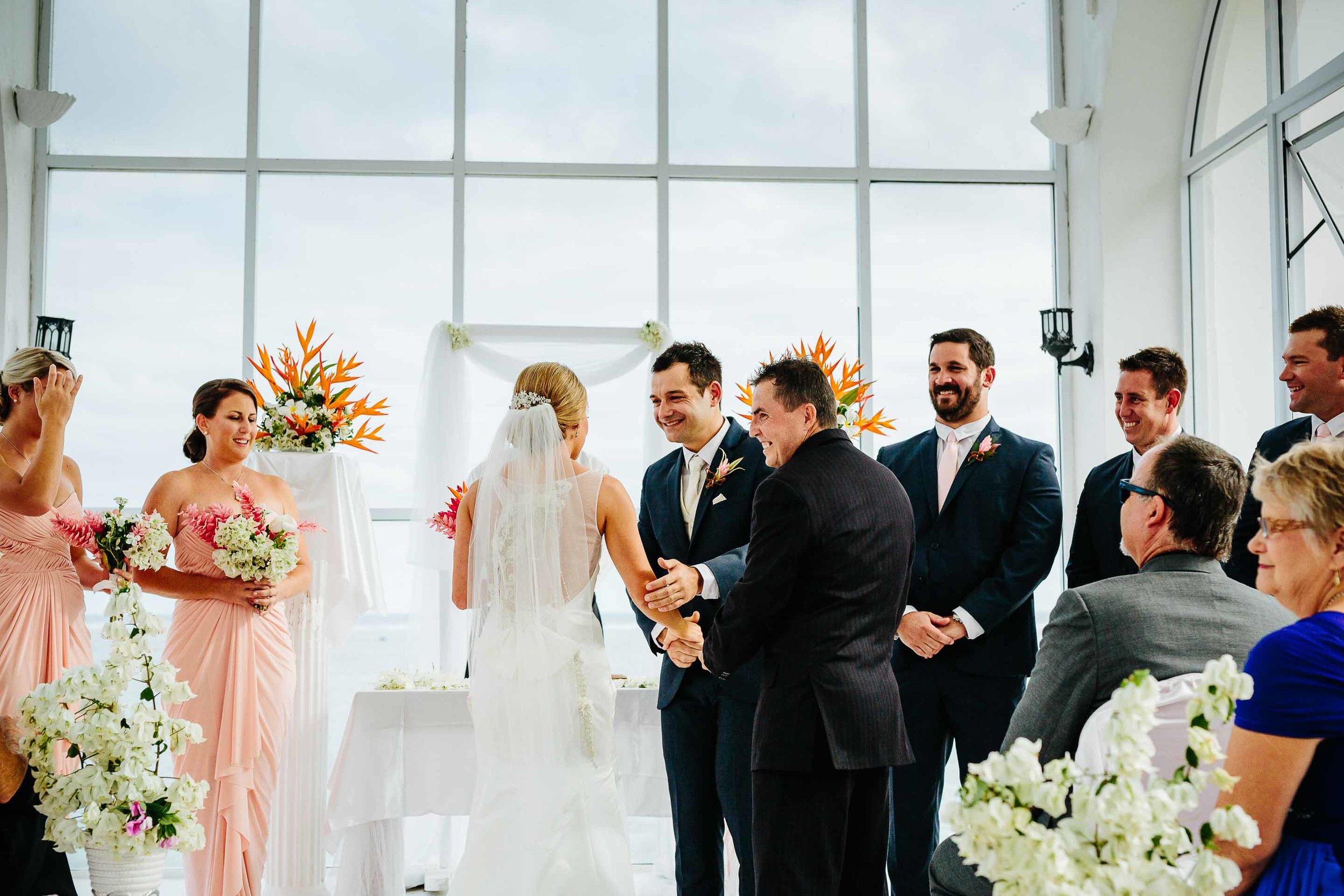 brides brother handing bride over to groom