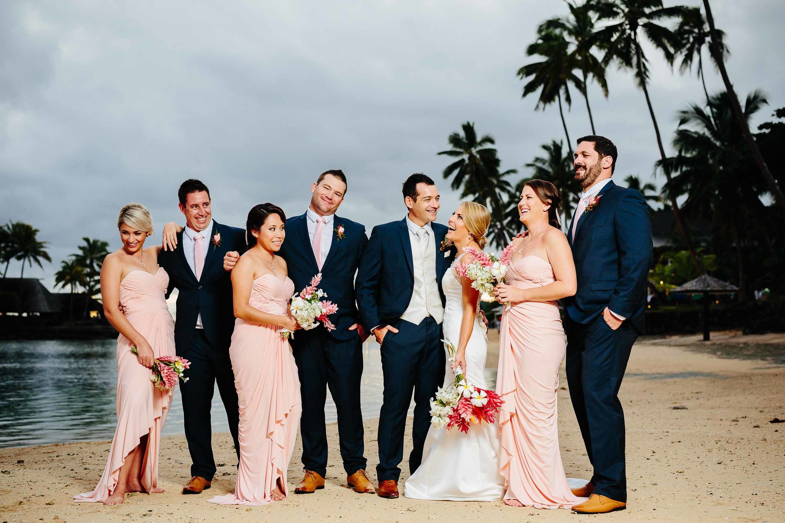 bridal party having fun on the beach