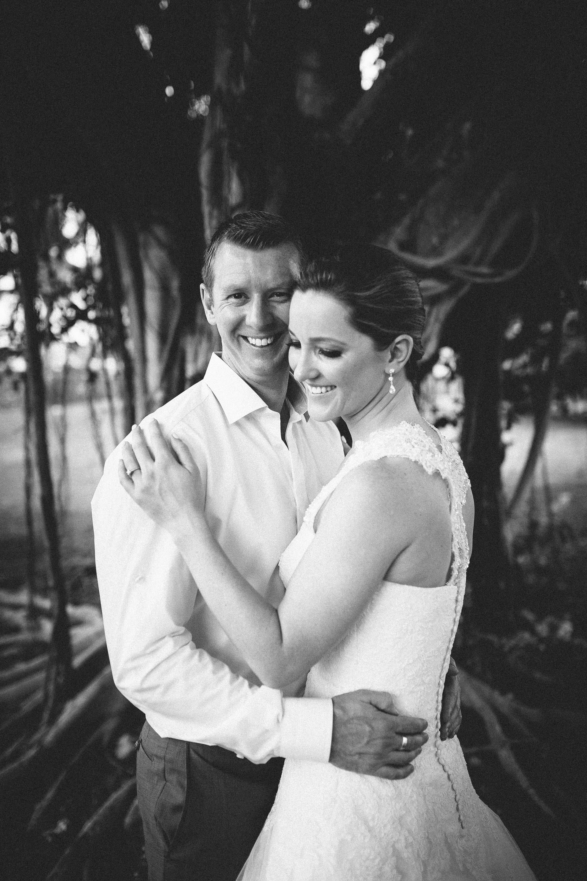 The bride and groom under a tree