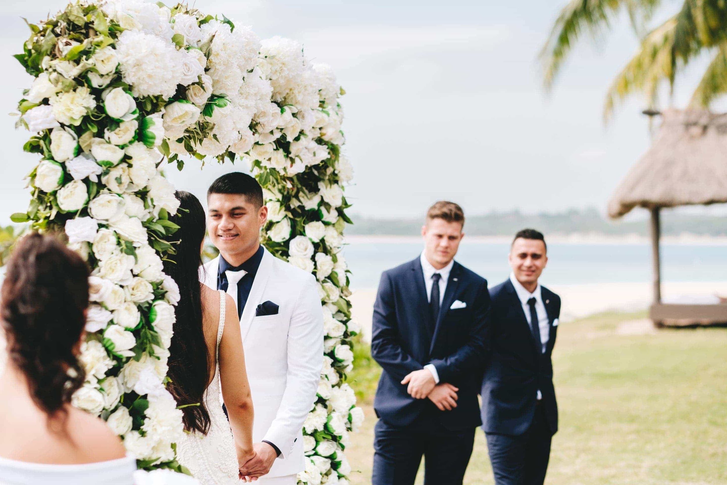 the groom says his vows during the wedding ceremony.