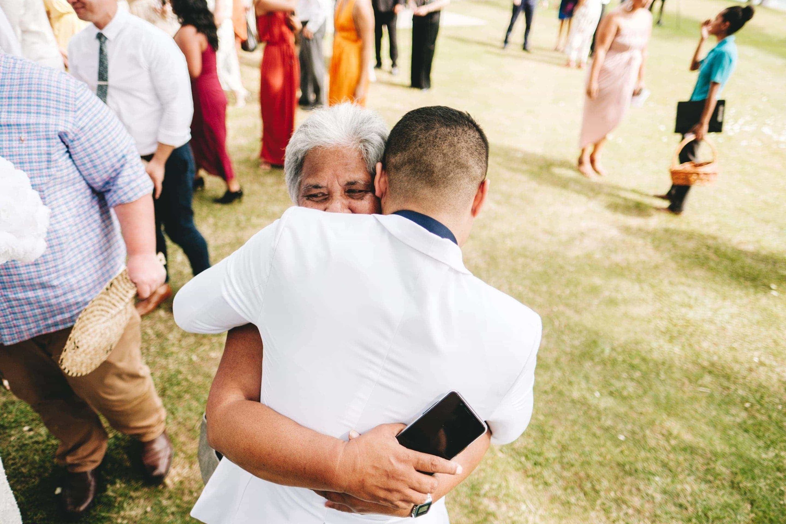 the groom embracing his grandmother after the ceremony