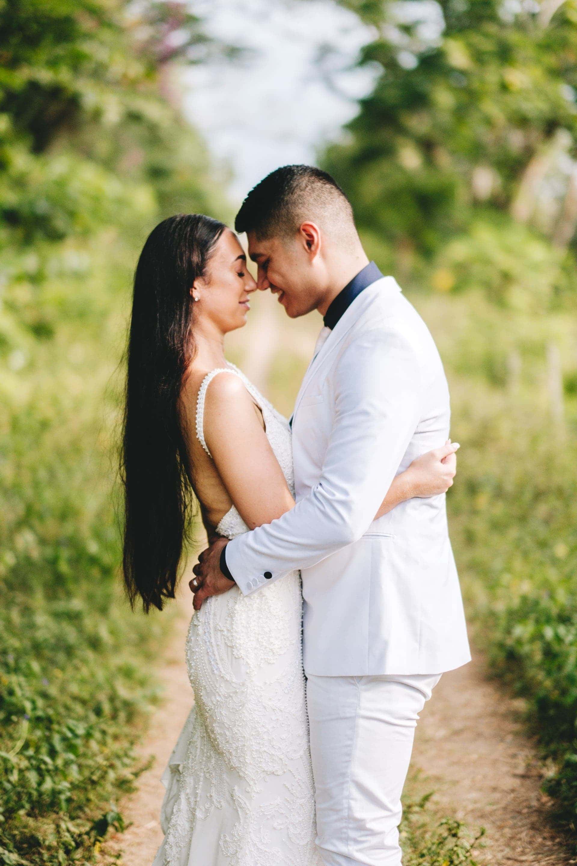 The bride and groom embrace on the old rusted train tracks that divides InterContinental Resort in two.