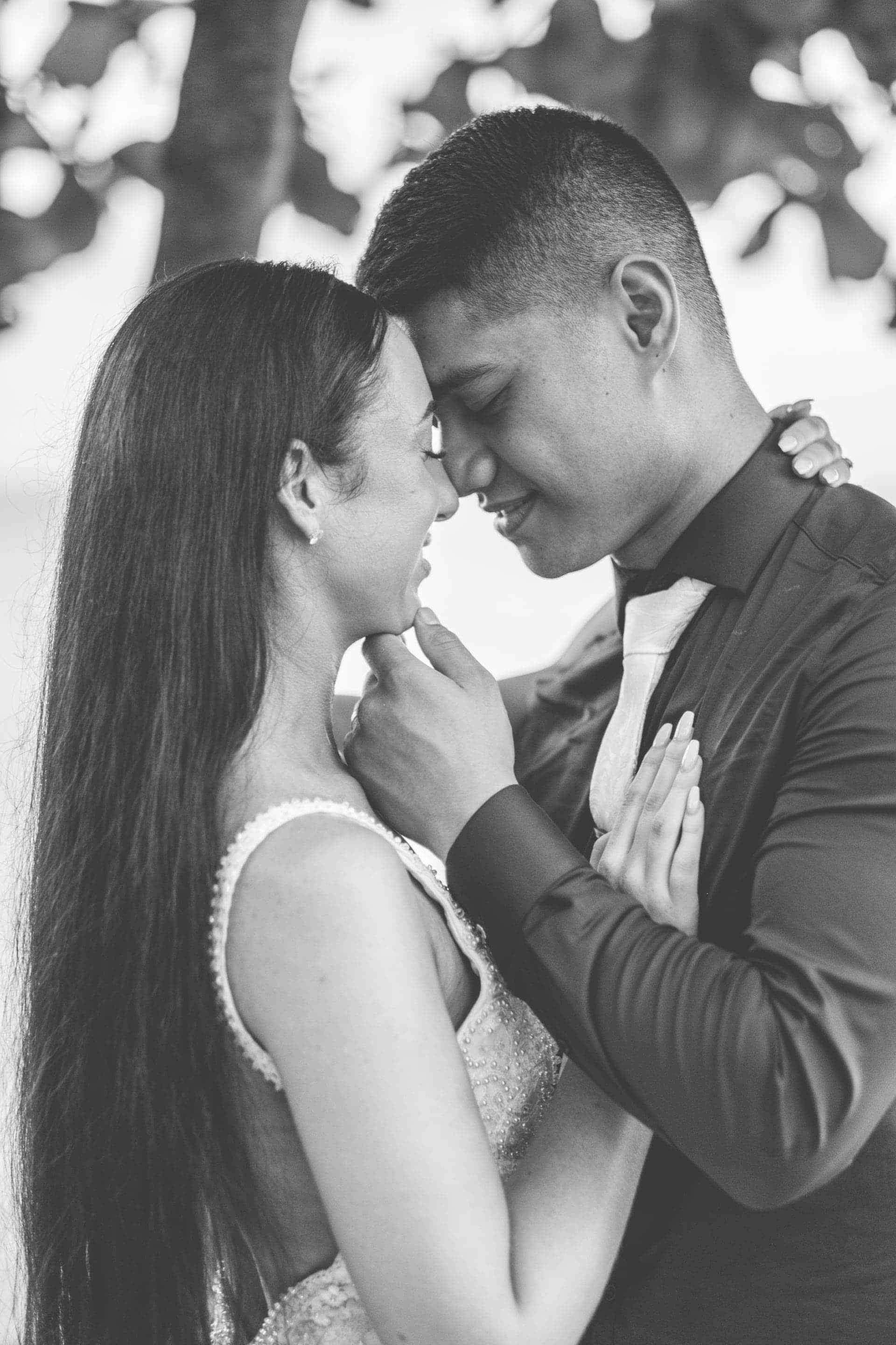 the groom gently pulling the brides chin up for a kiss