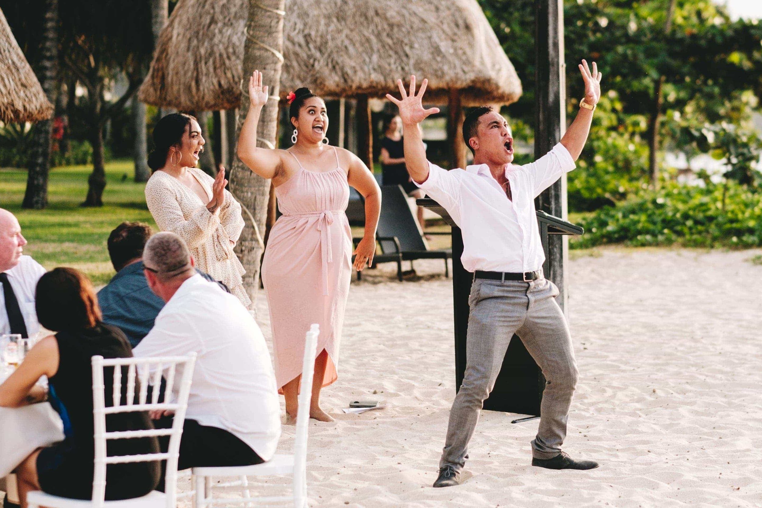 Father of the groom and family preform a haka for the wedding couple