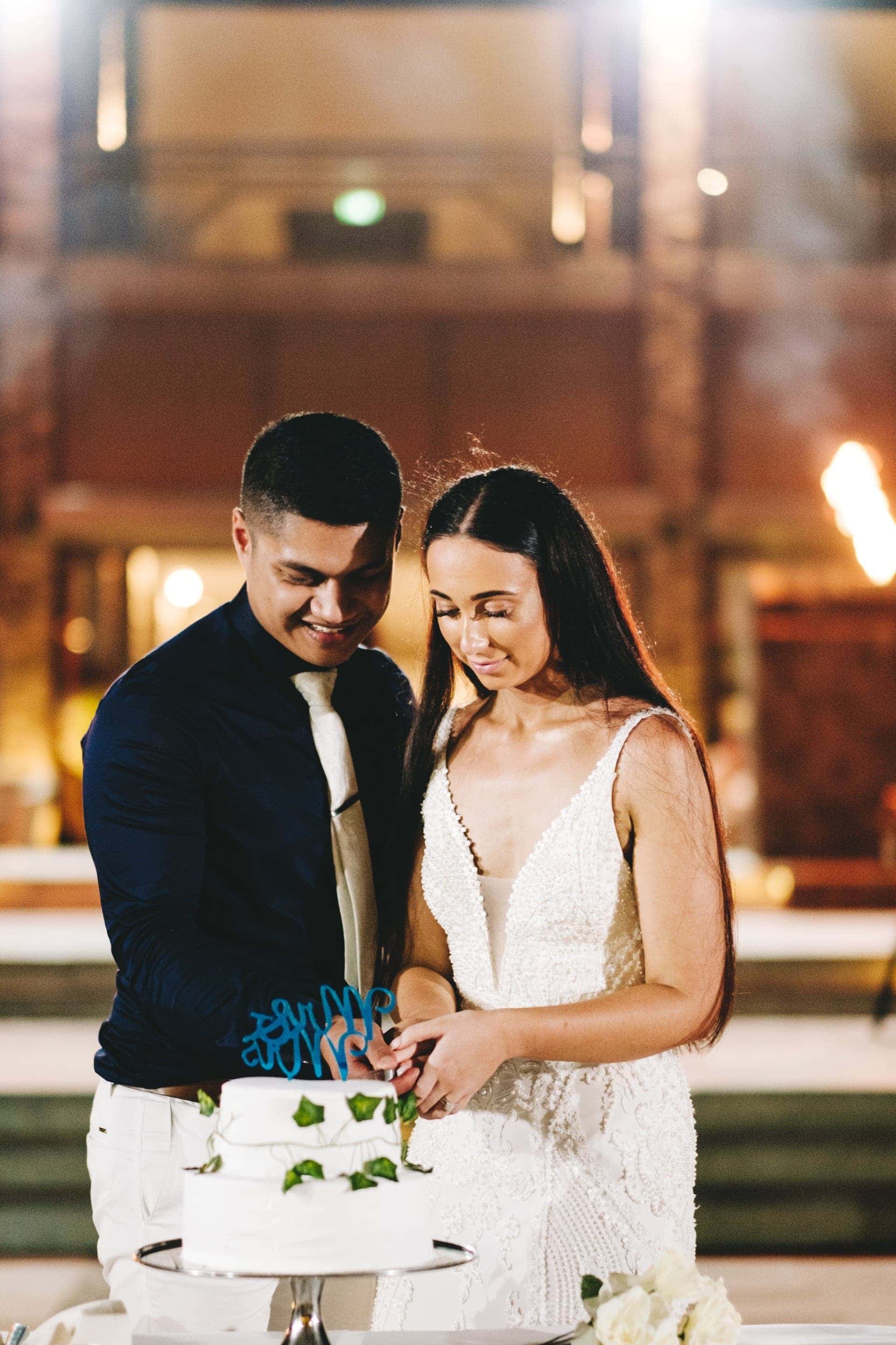 the bride and groom cut the cake