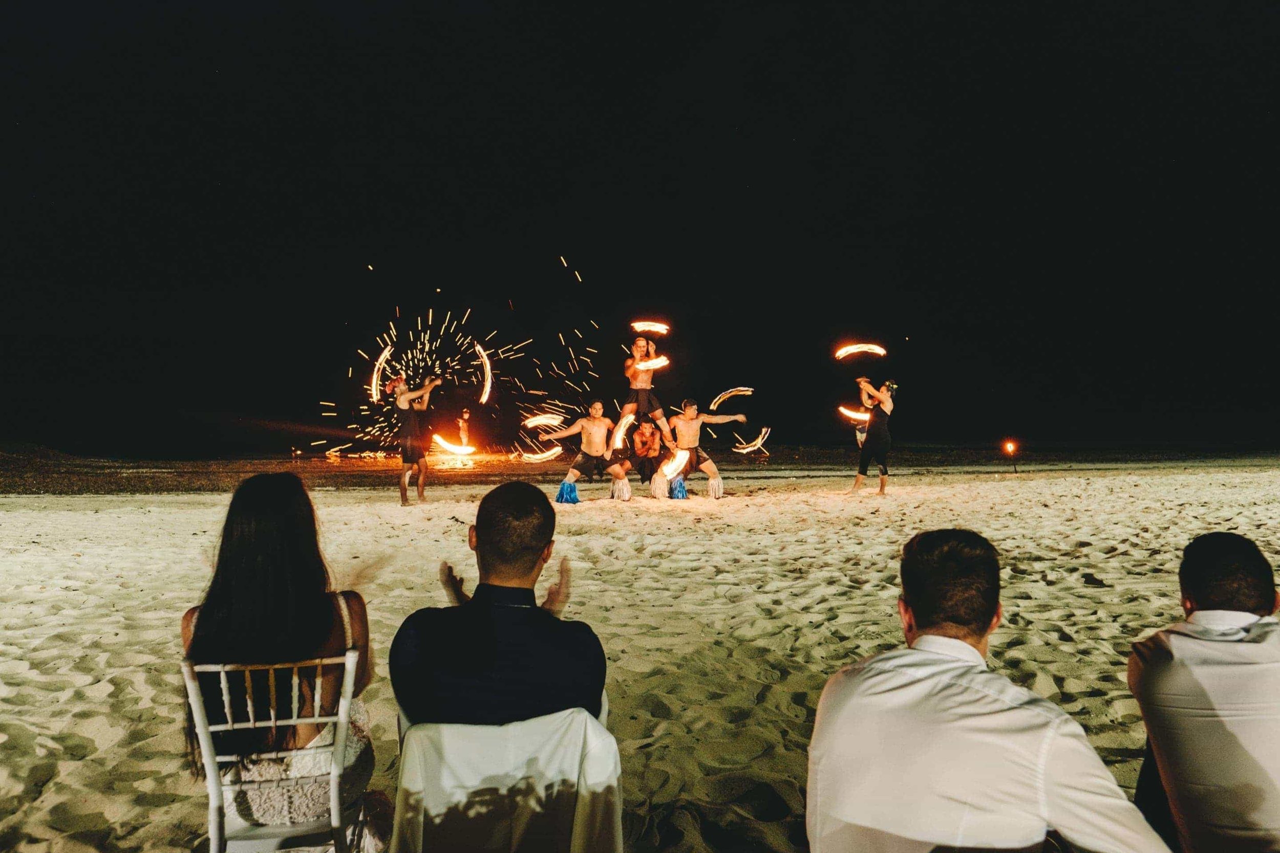 Polynesian fire dancers preform for the wedding guests.