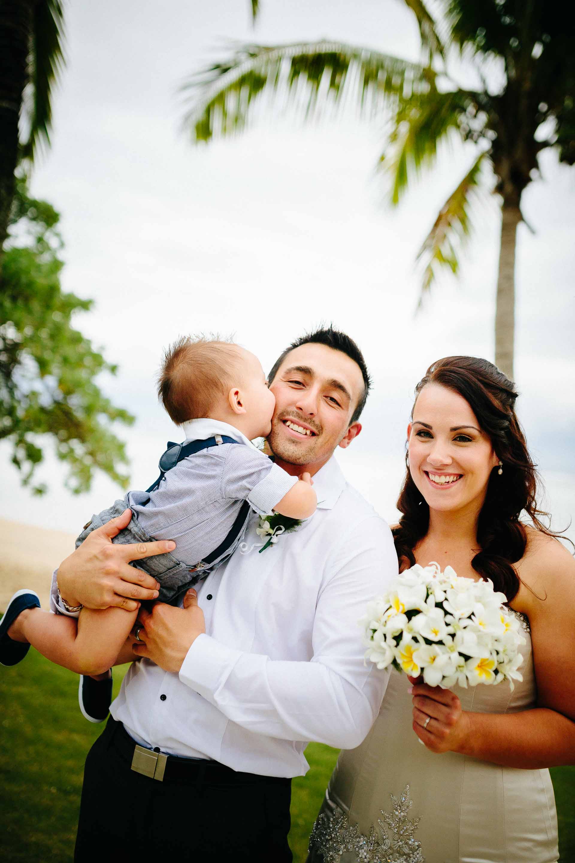 bride and groom with their son