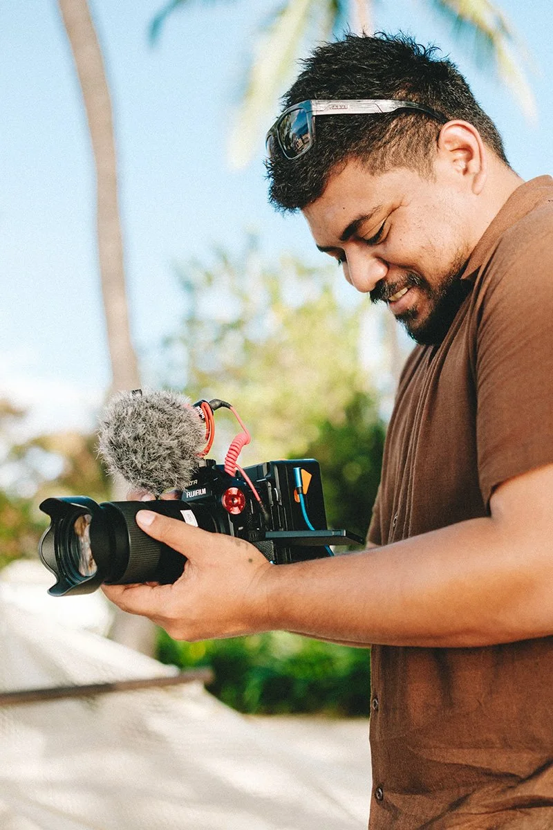 Senior Wedding Videographer Mike Lee handholding he's camera while shooting a wedding at the Sofitel Fiji Resort and Spa