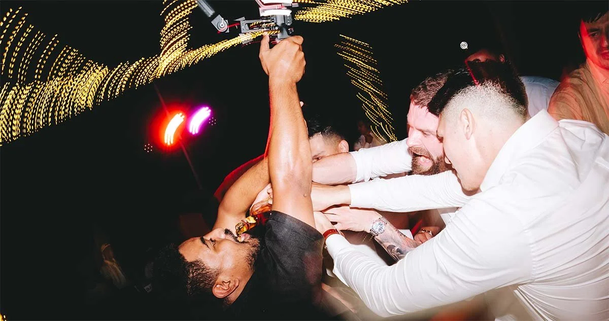 Mike our videographer being forced a swig of Fireball while filming on the dancefloor