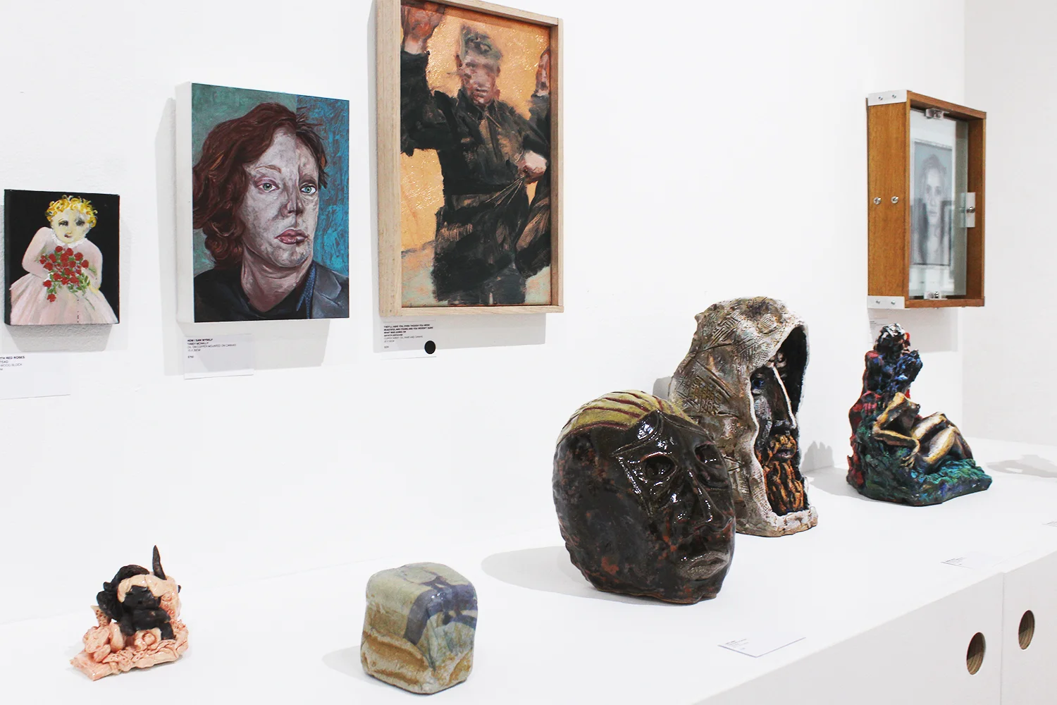 From top left to bottom right: Kate Stead, girl with red roses , oil on wood block, 11x9cm; Tansy McNally, How I Saw Myself, oil on copper mounted on canvas, 15x20cm; Marion Abraham, They'll Have You, Even Though You Were Beautiful And Young And You Weren't Sure What Was Going On , copper sheet, oil paint & canvas, 22x33cm; Rhiannon Gamble, Dislocation , fine art ink jet prints on transparency film between glass, 24x31x4cm; Nani Puspasari, A land not mine , hand-built earthenware ceramic and glaze, 11x7x7cm; Rosalind Porter, Lost Man, ceramic, 20x15x16cm; James Rhodes, Fragile Foundry 4, Emulsion on Rock, dimensions variable; Alex & Ruv Nemirovsky , Gitarist , oil paints on fired clay, 27x9x7cm, Diana and Zeus , oil paints on fired clay, 26x20x17cm, Russian artist , oil paints on fired clay, 27x16x14cm.