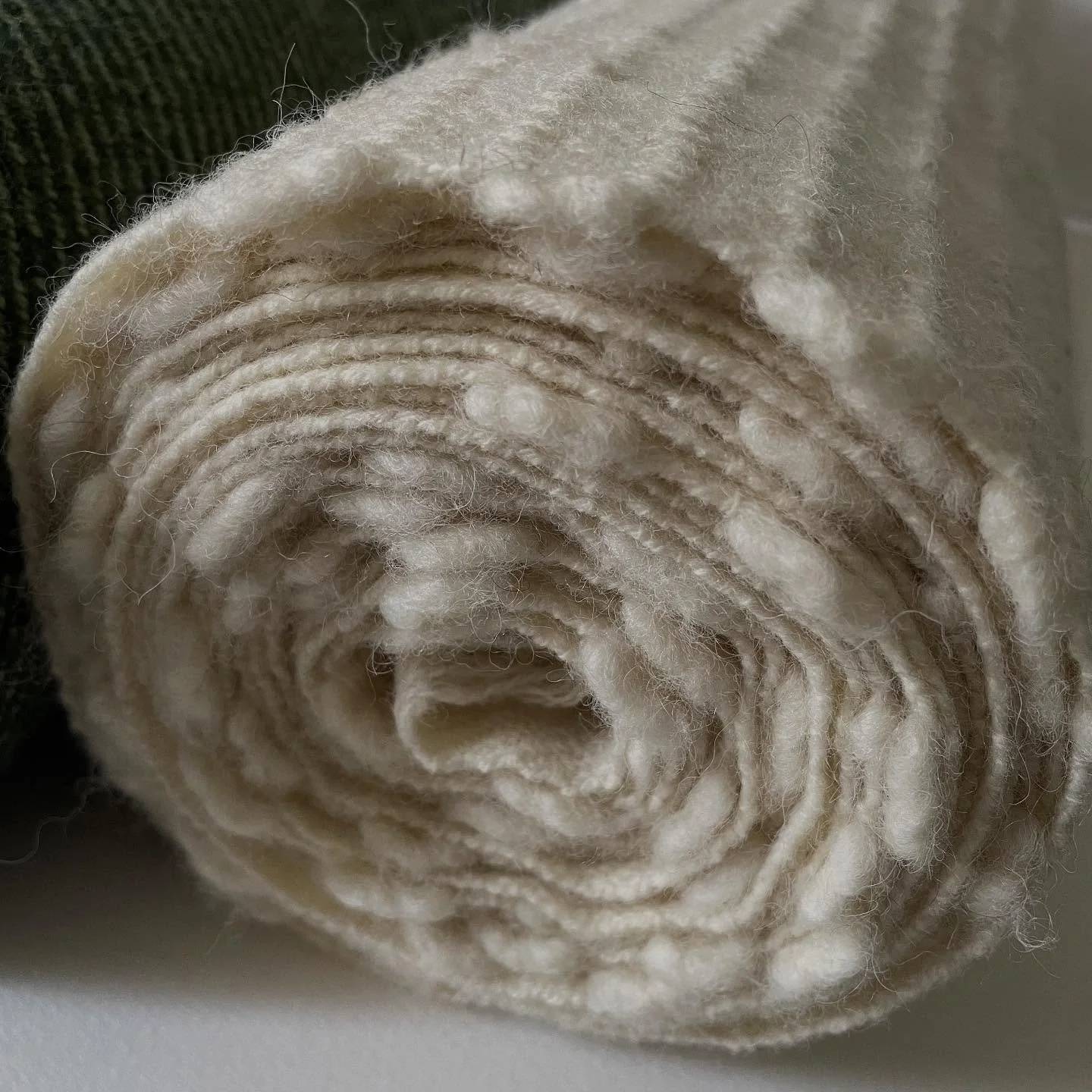 Last seen on the loom this 7-metre length of cloth has now been washed and pressed and is ready to be made into a blanket.  Although there's a lot of work still to do I love to see the cloth rolled up like this, it has so much potential

#handwovente