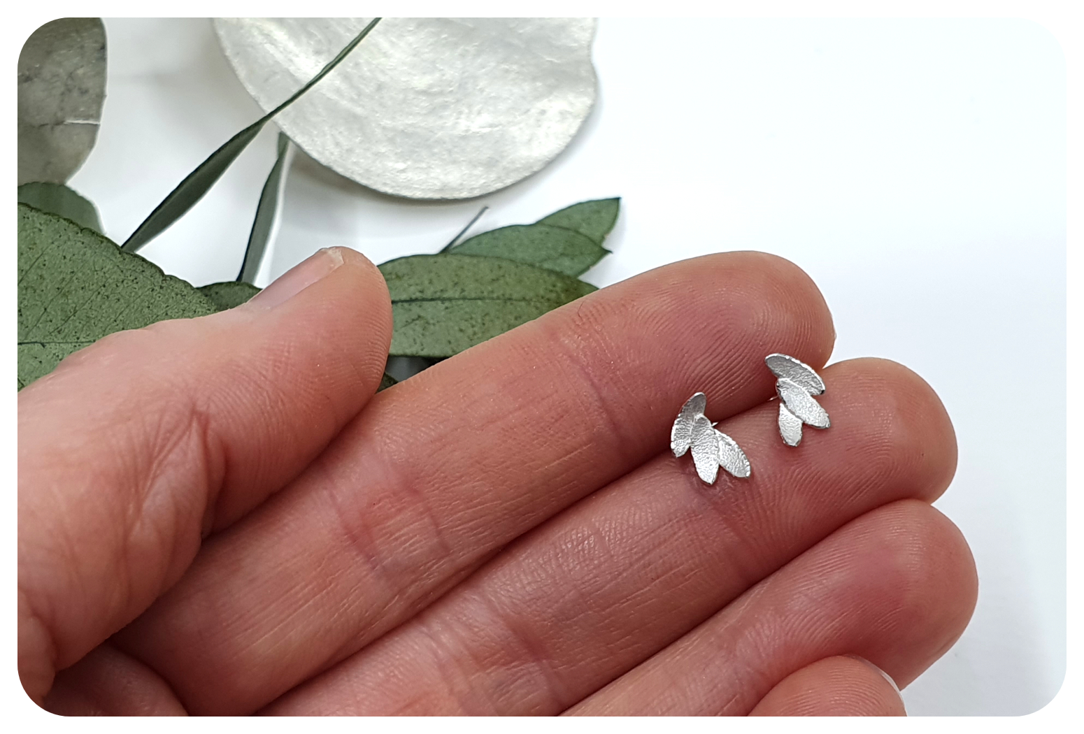 tiny leaves studs in hand.png