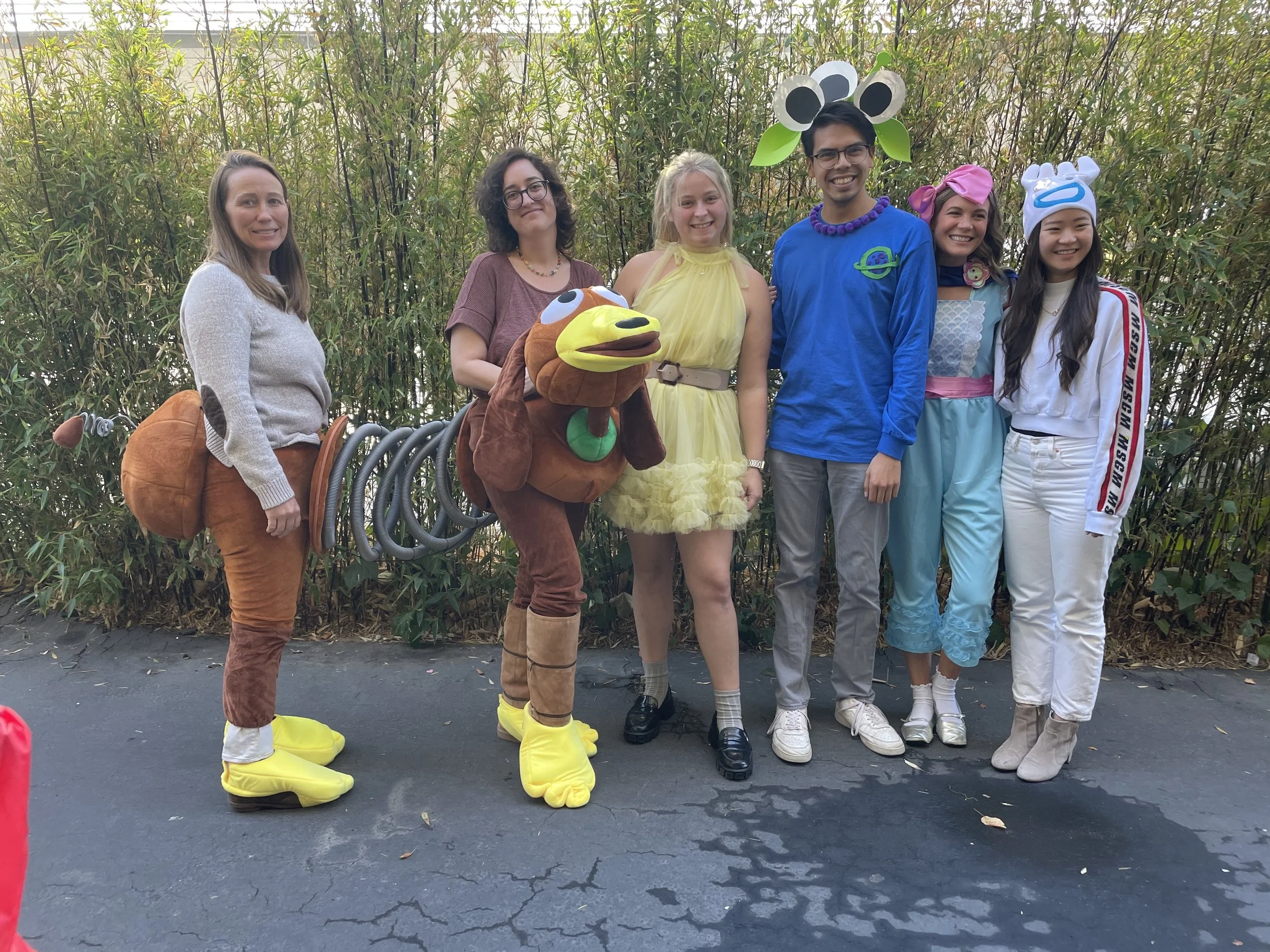 Group of teachers dressed in fun costumes, smiling together outside..jpg