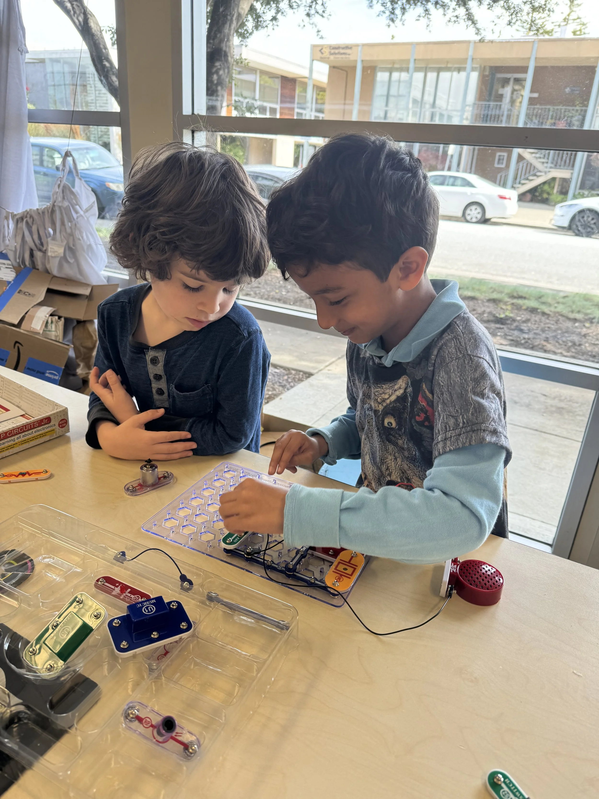 Students building a circuit project together at a classroom table..jpeg