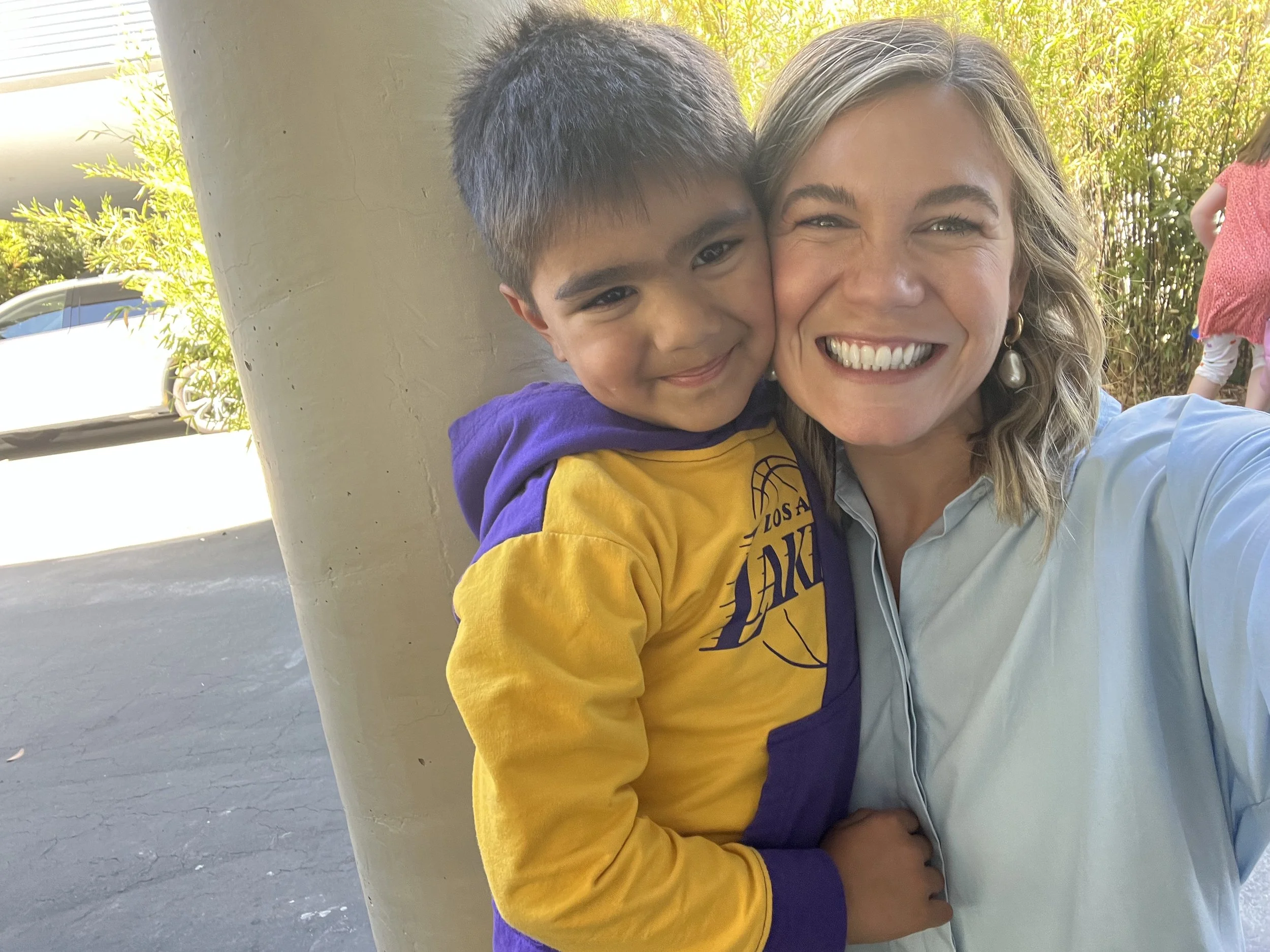 Teacher and student smiling together outside at school..jpg