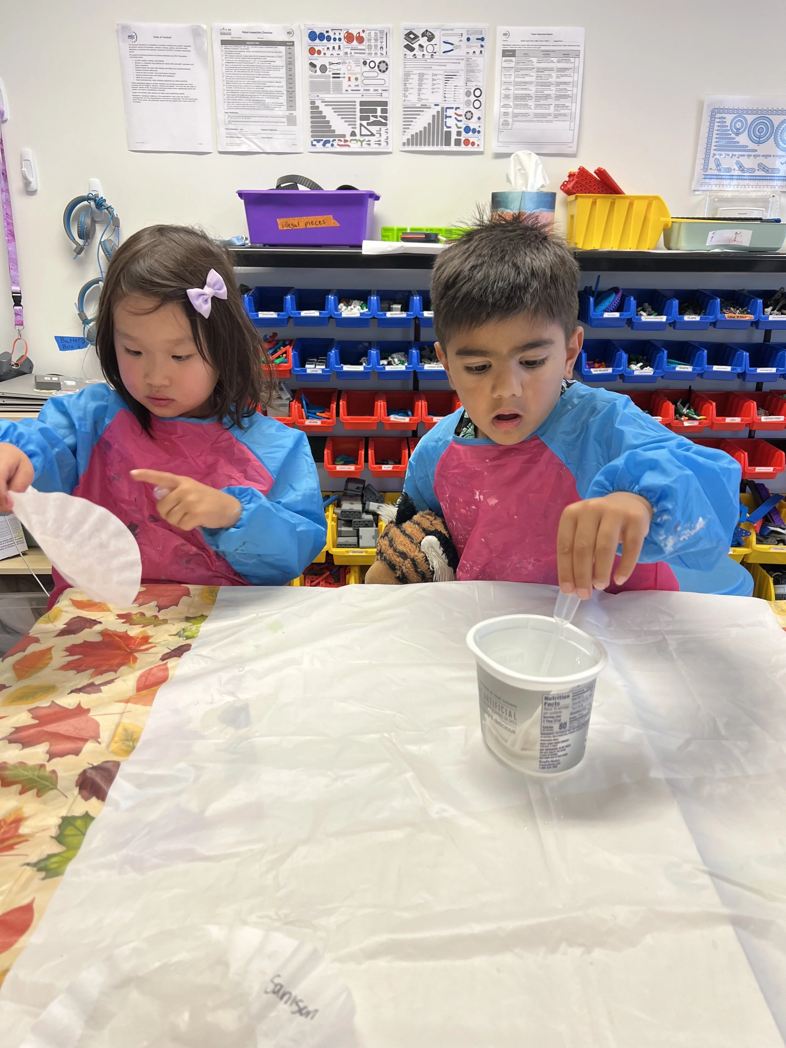 Young students working on a hands-on art project in the classroom.