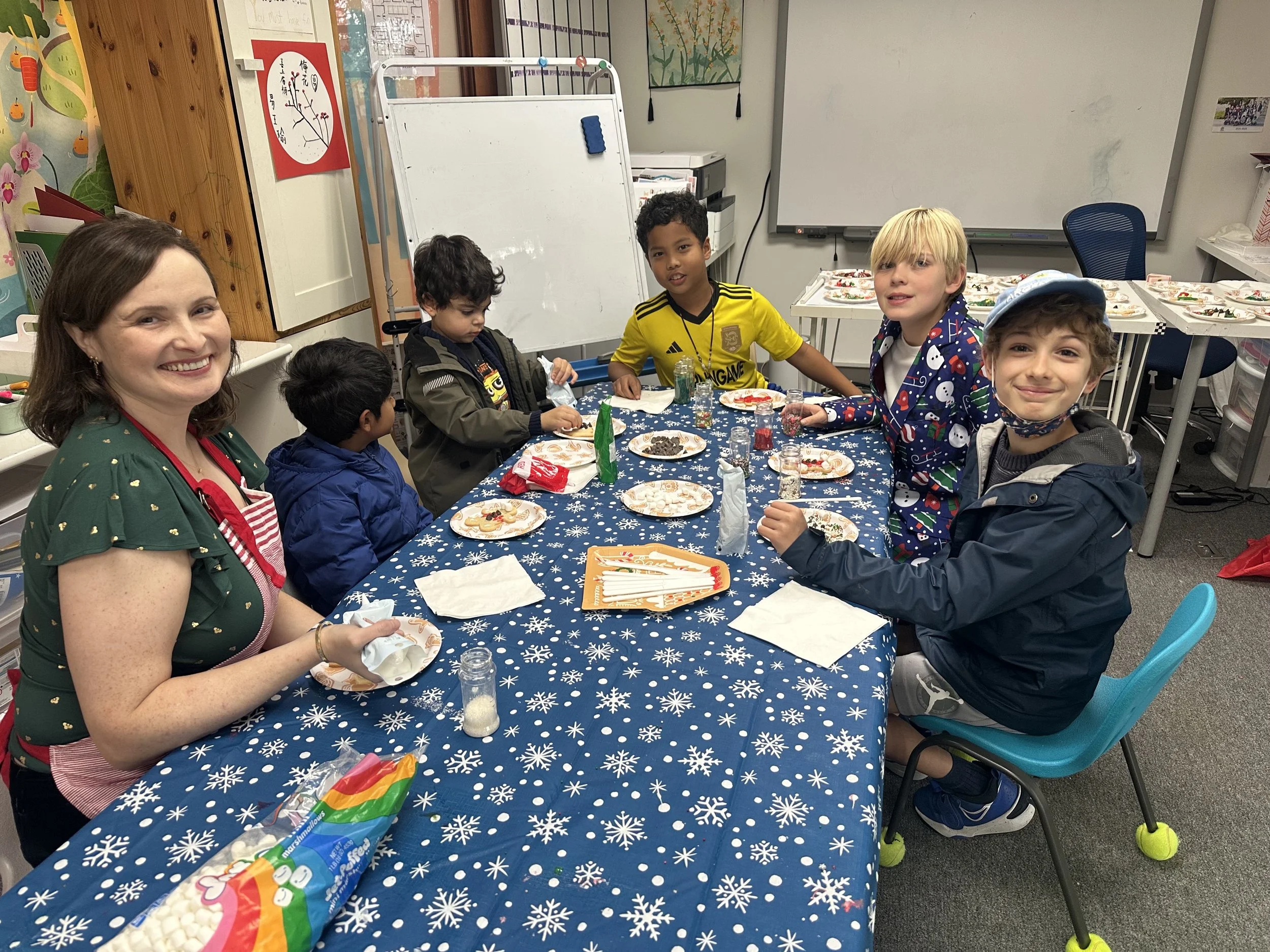 Teacher and students enjoying a holiday classroom activity together.