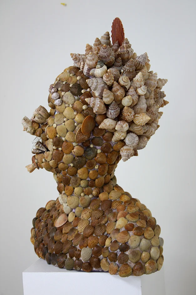 Lady from Atlantis (with deep tan) 2011 Shell, polystyrene, glass eyes, wig, steel stand