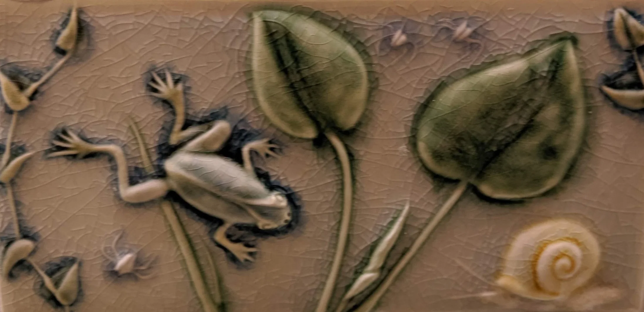 Tile detail illustrates the pond motif.