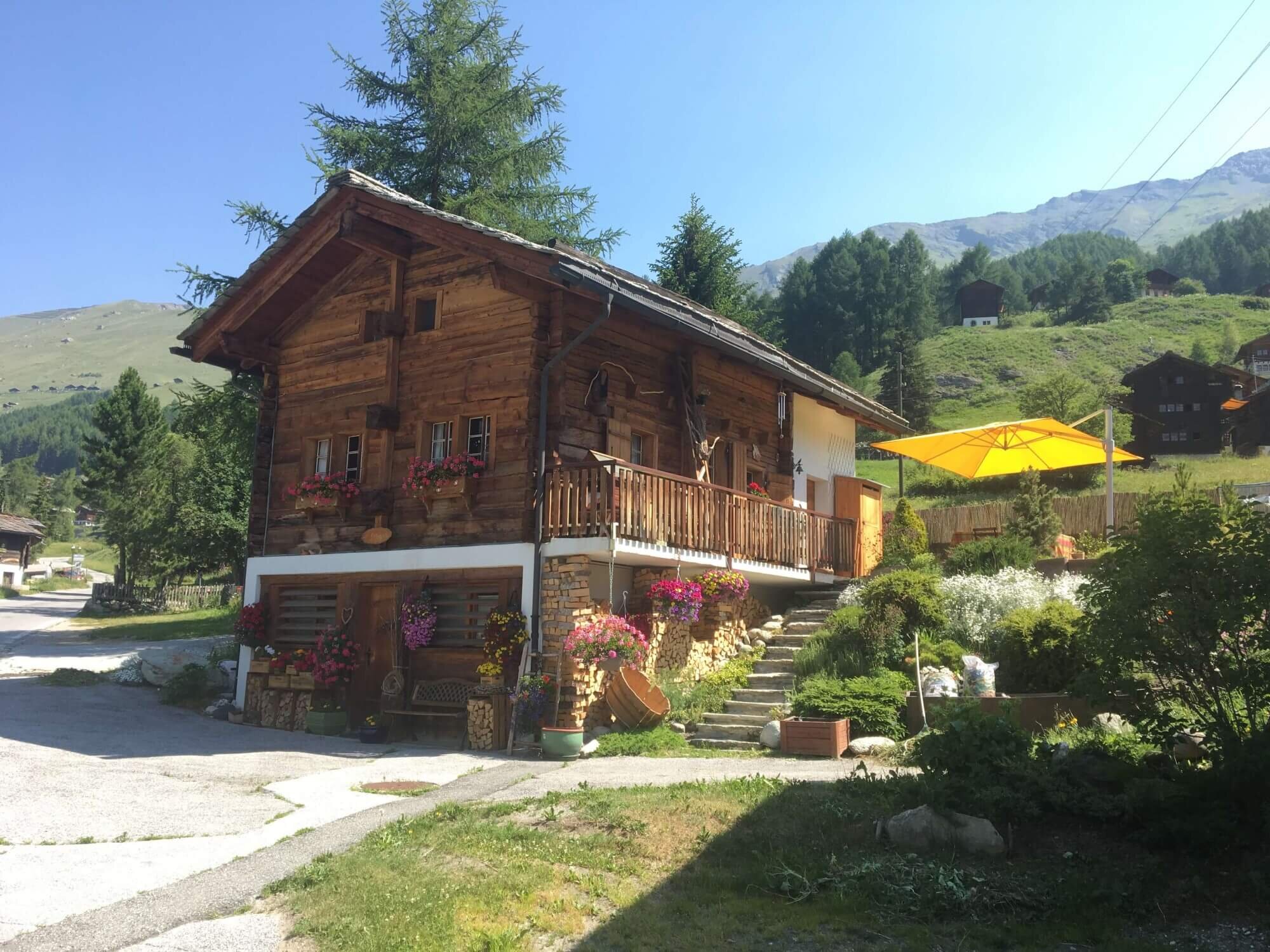 Traditional alpine houses decorated with flowerboxes in La Sage