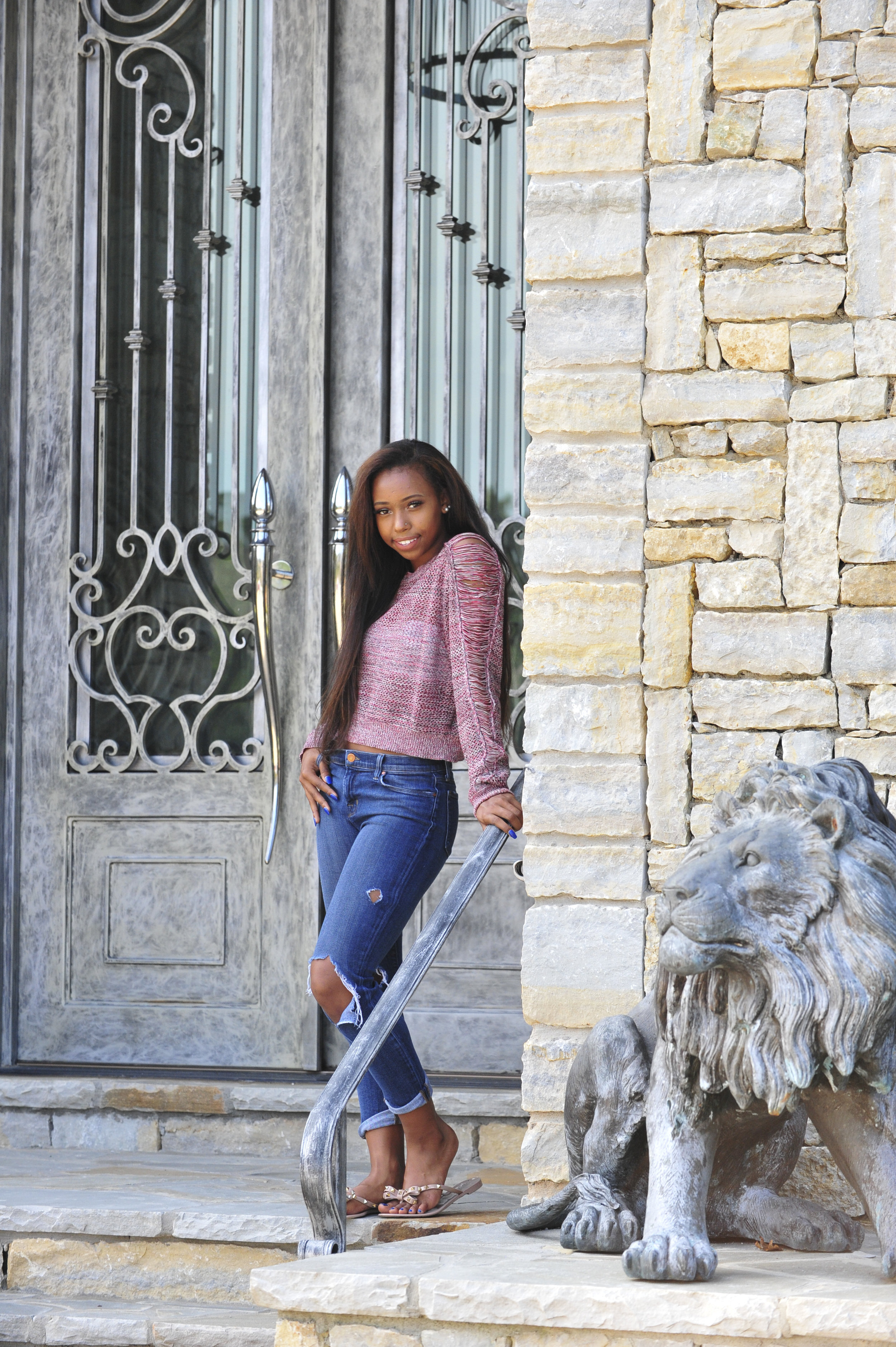 Senior pictures girl on location with stone lion