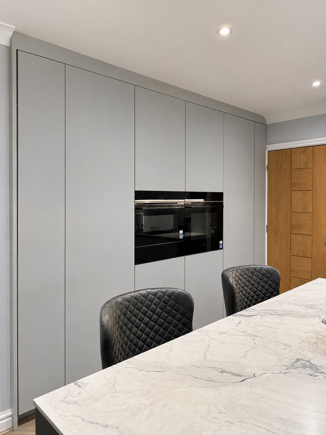 01-two-tone-grey-handleless-kitchen-tall-units-siemens-ovens.png