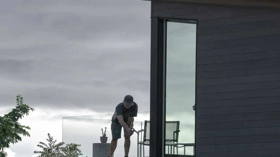 Window cleaner on the lanai of a modern home in Pukalani, Maui
