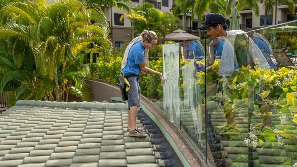 Window cleaners cleaning glass railings at a Maui resort