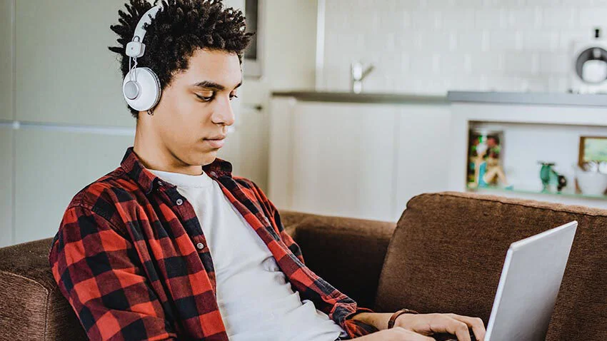 Student_on_laptop_at_home_on_couch.jpg