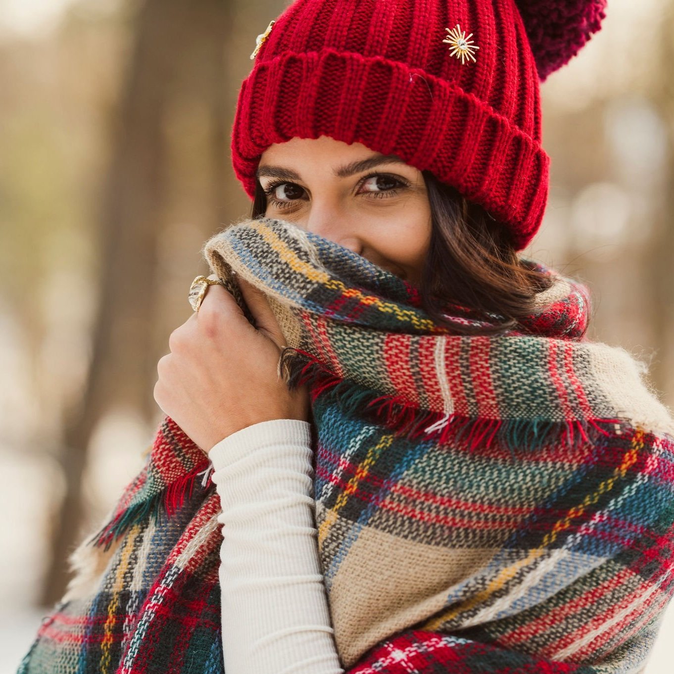 Red winter hat and oversized plaid scarf.