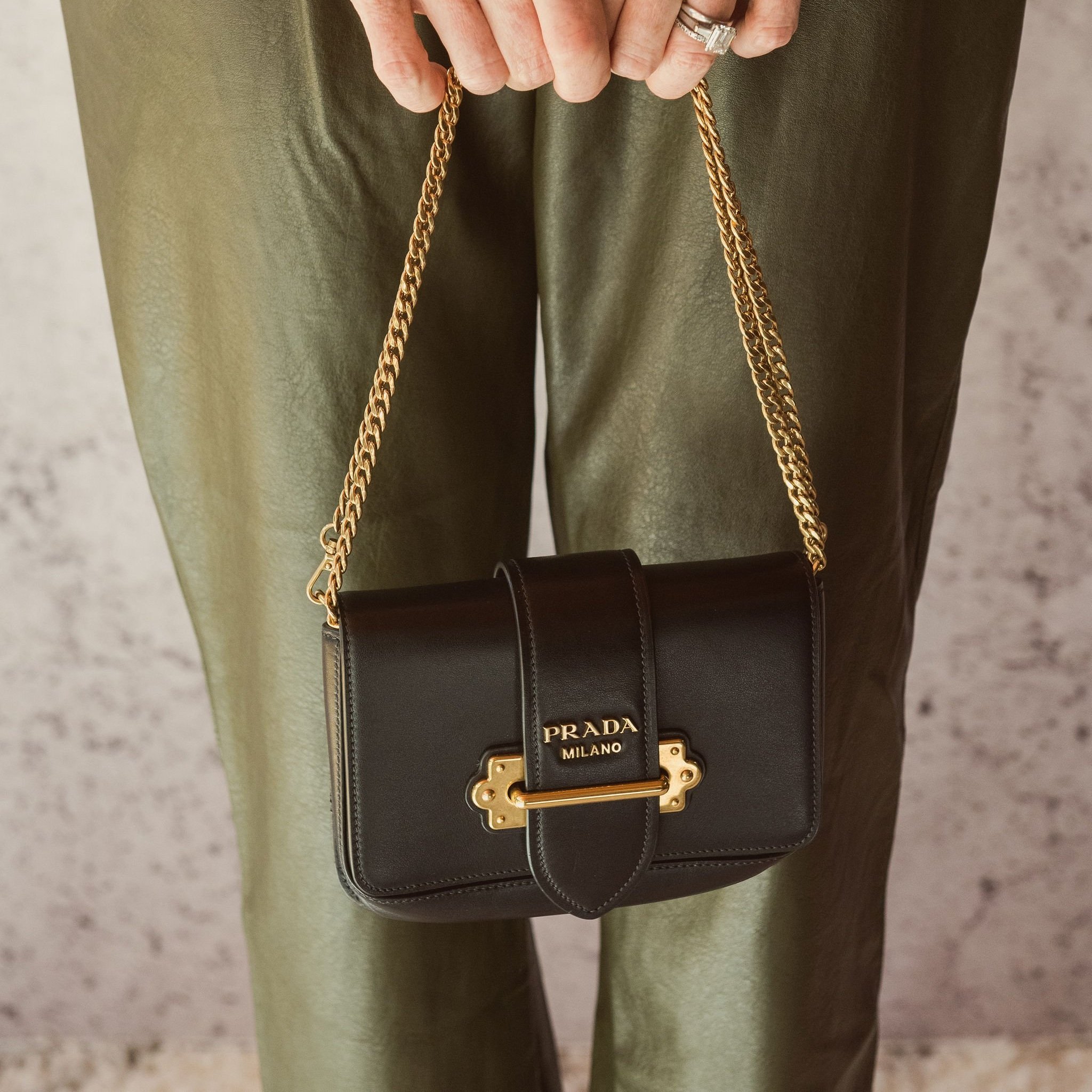 Black Prada purse with gold chain strap.