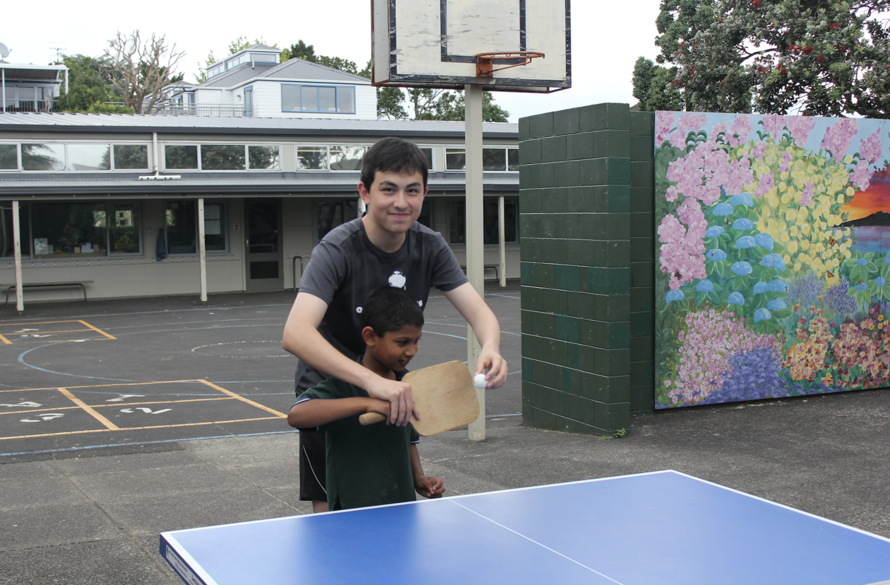 Leo Mamedov teaching a student from Epsom Normal Primary school on how to hold a bat correctly