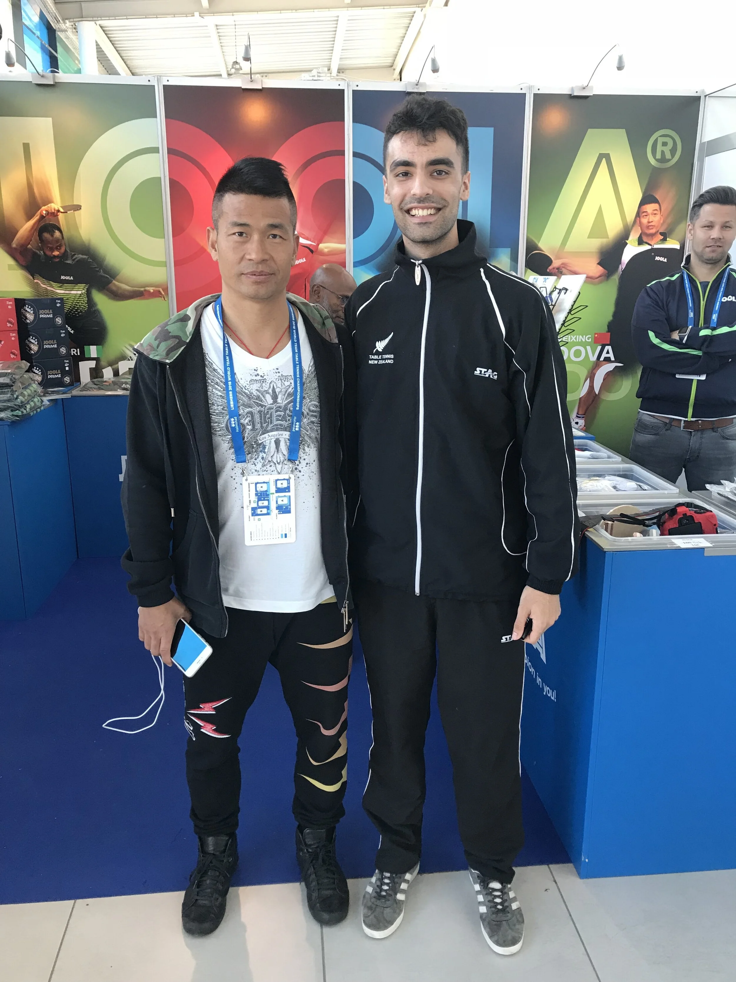 A photo of Dinyar Irani (NZL) and Chen Weixing (AUT)