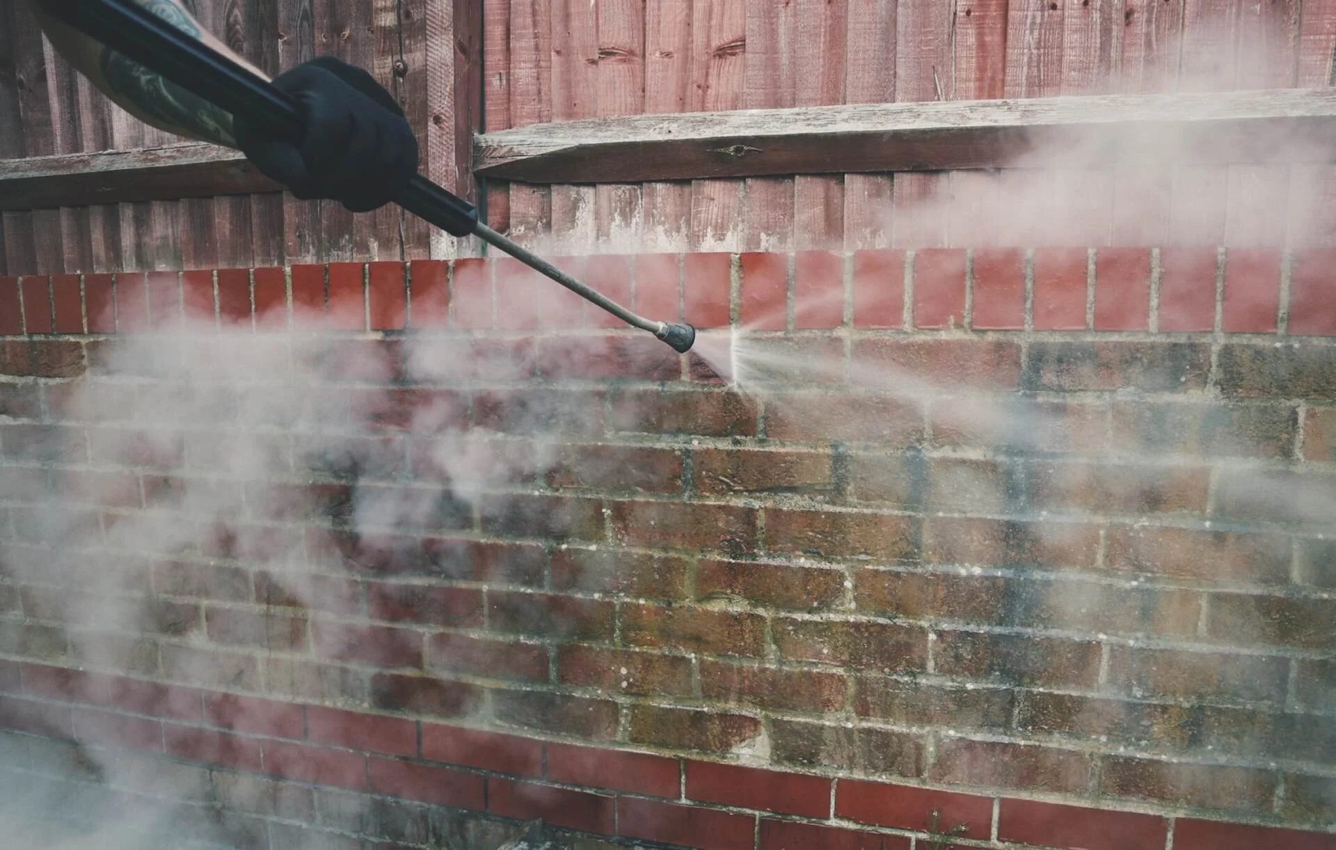 Professional brick cleaning in London removing algae and dirt from exterior brickwork
