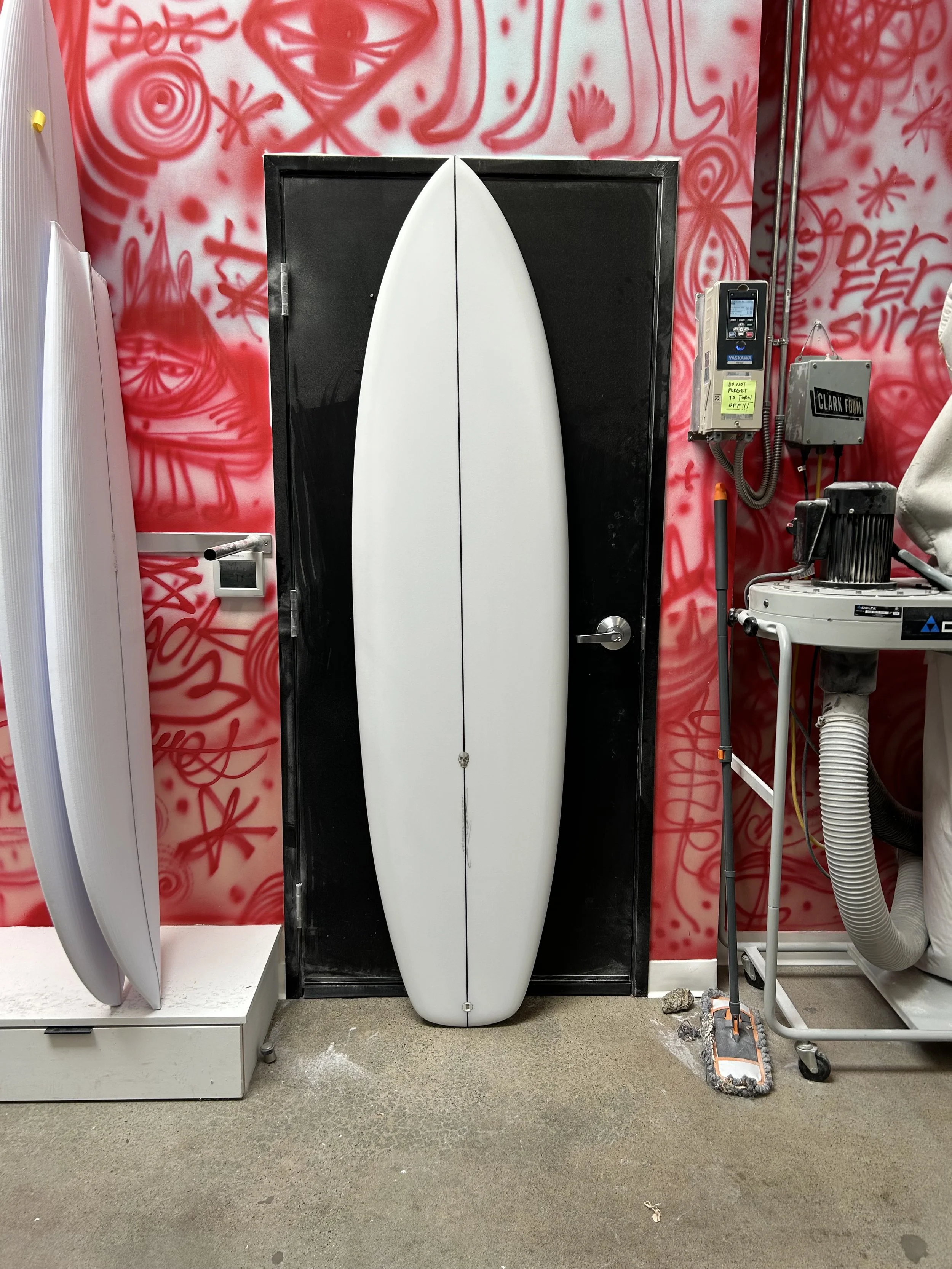 surfboard against black door