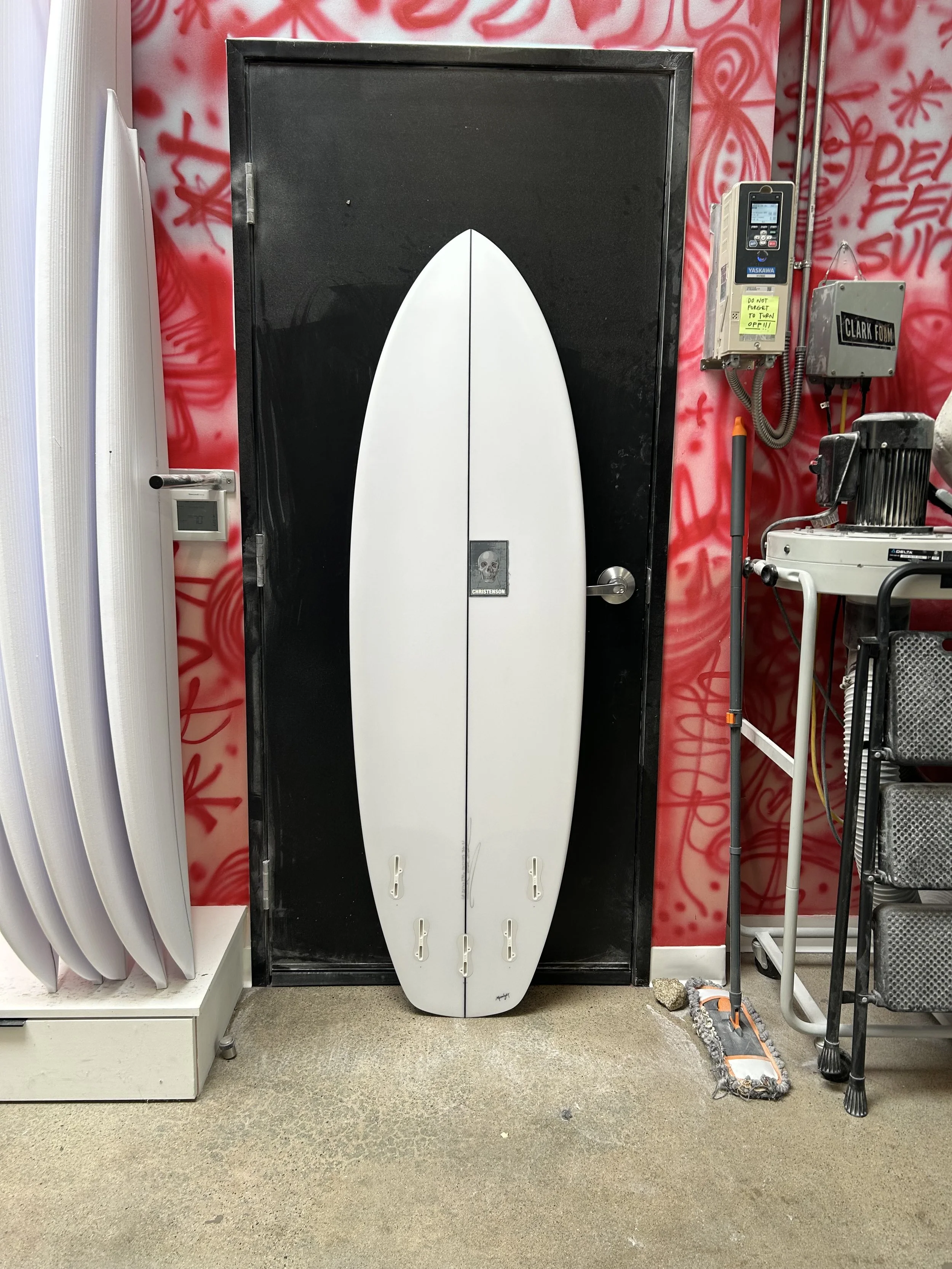 white easy wind against black shop door bottom of board