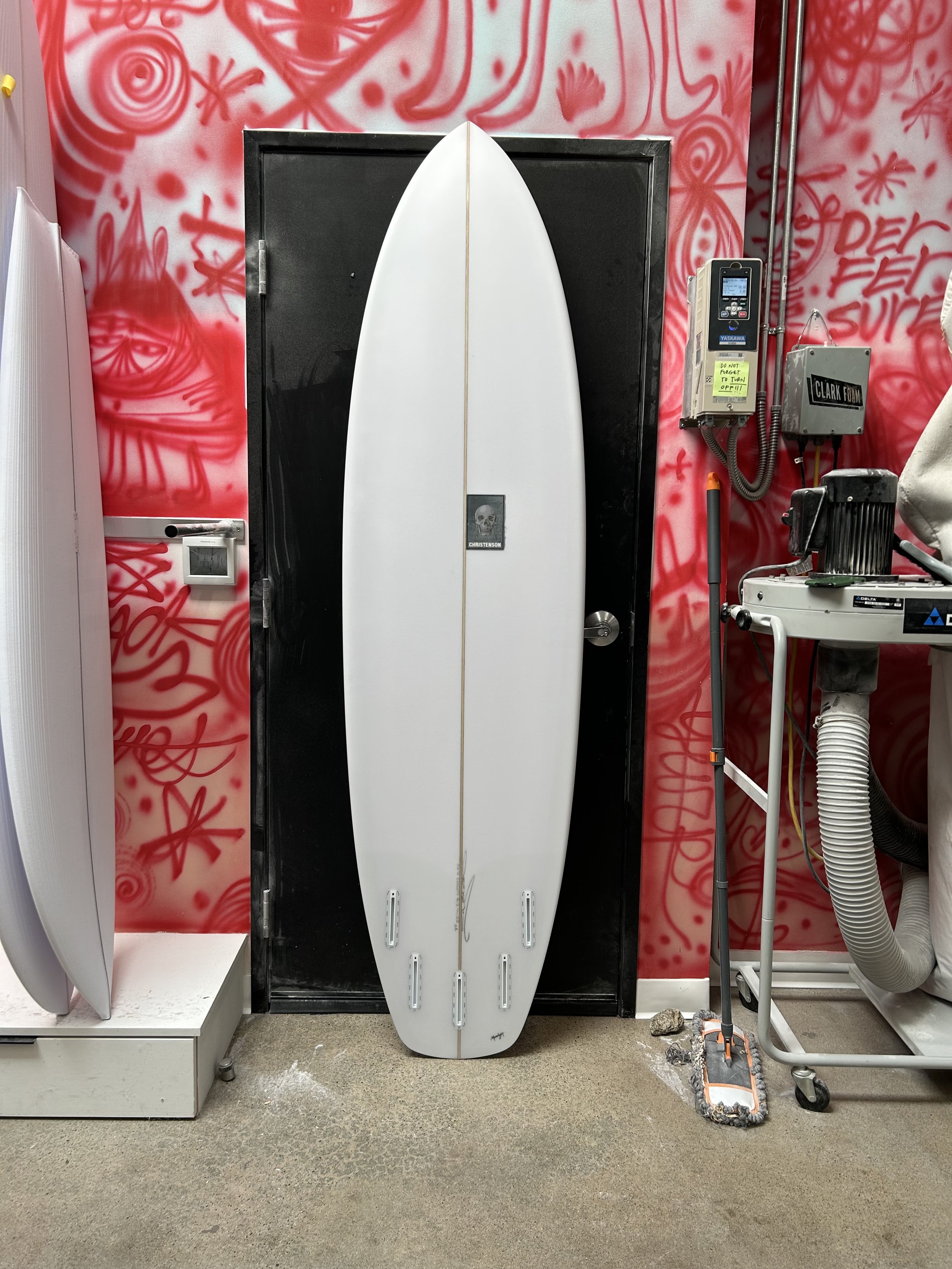 surfboard against black door