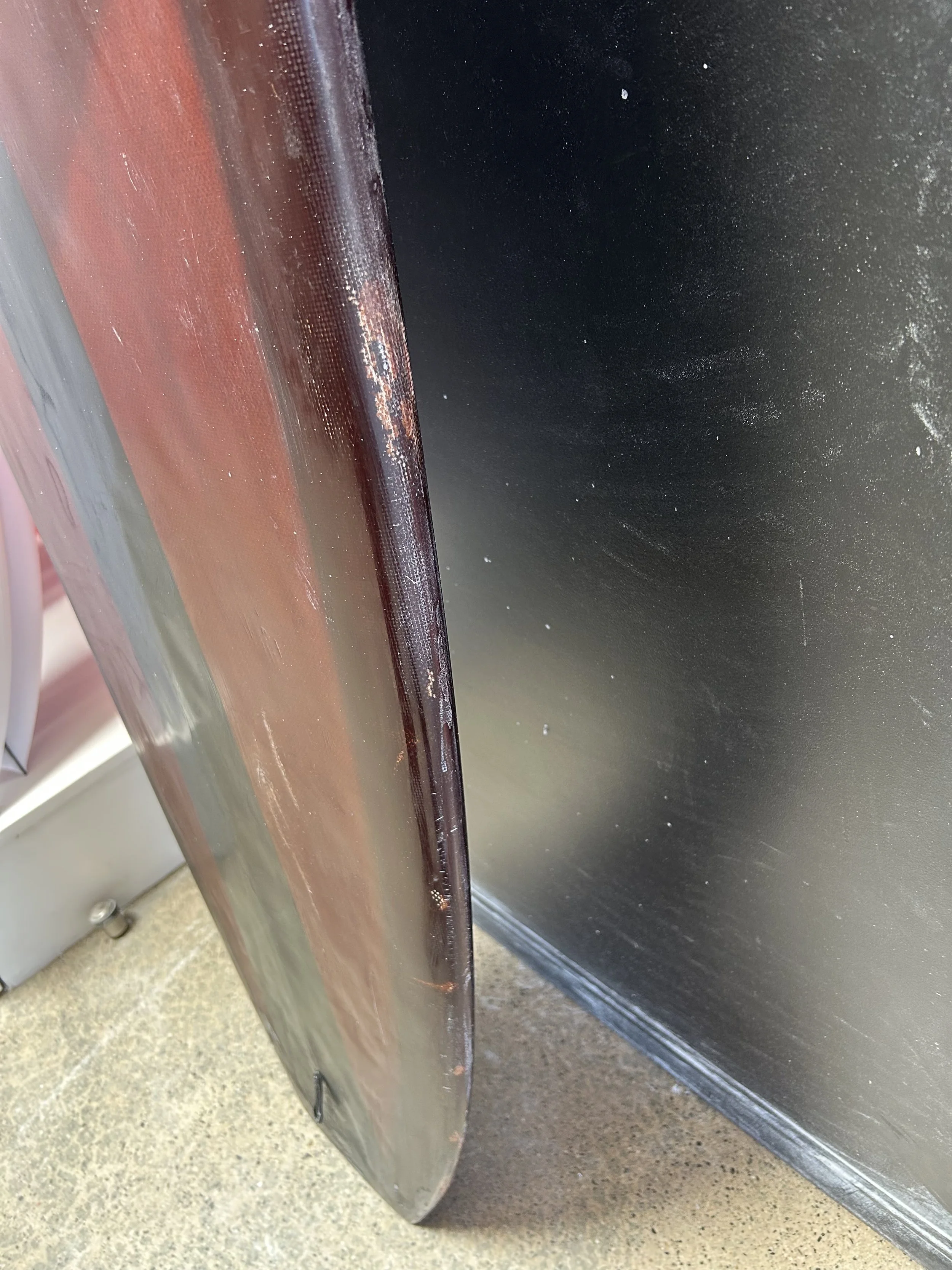 rail damage on brown used longboard