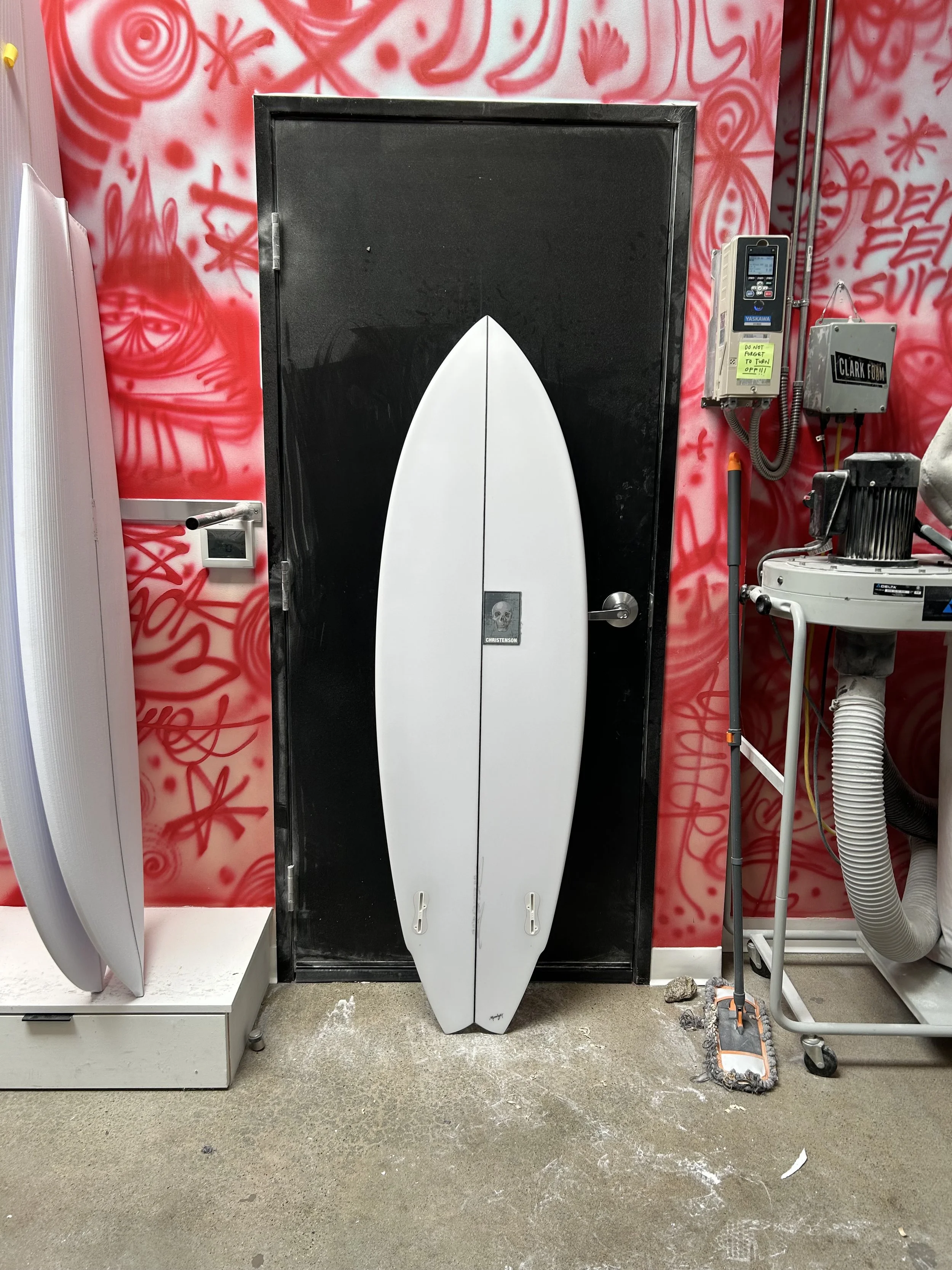 lane splitter surfboard against a black door