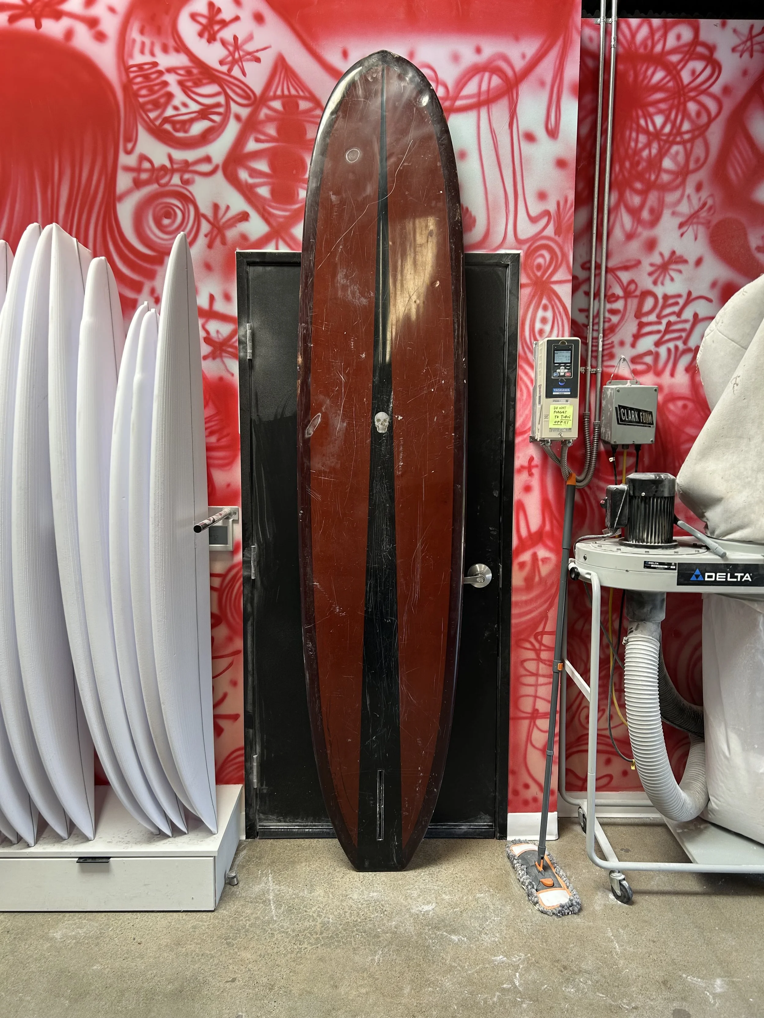 brown used longboard bottom