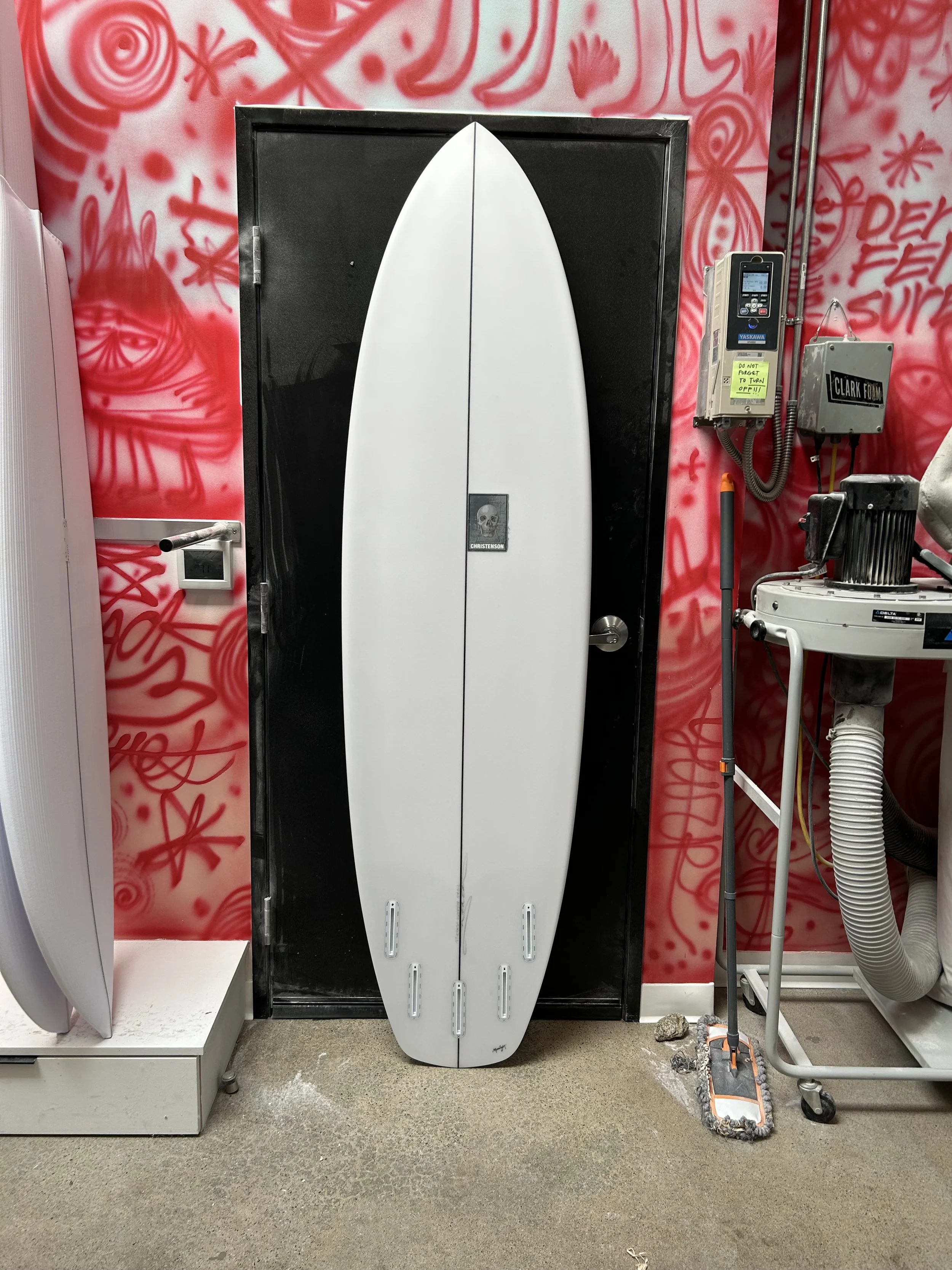 surfboard against black door