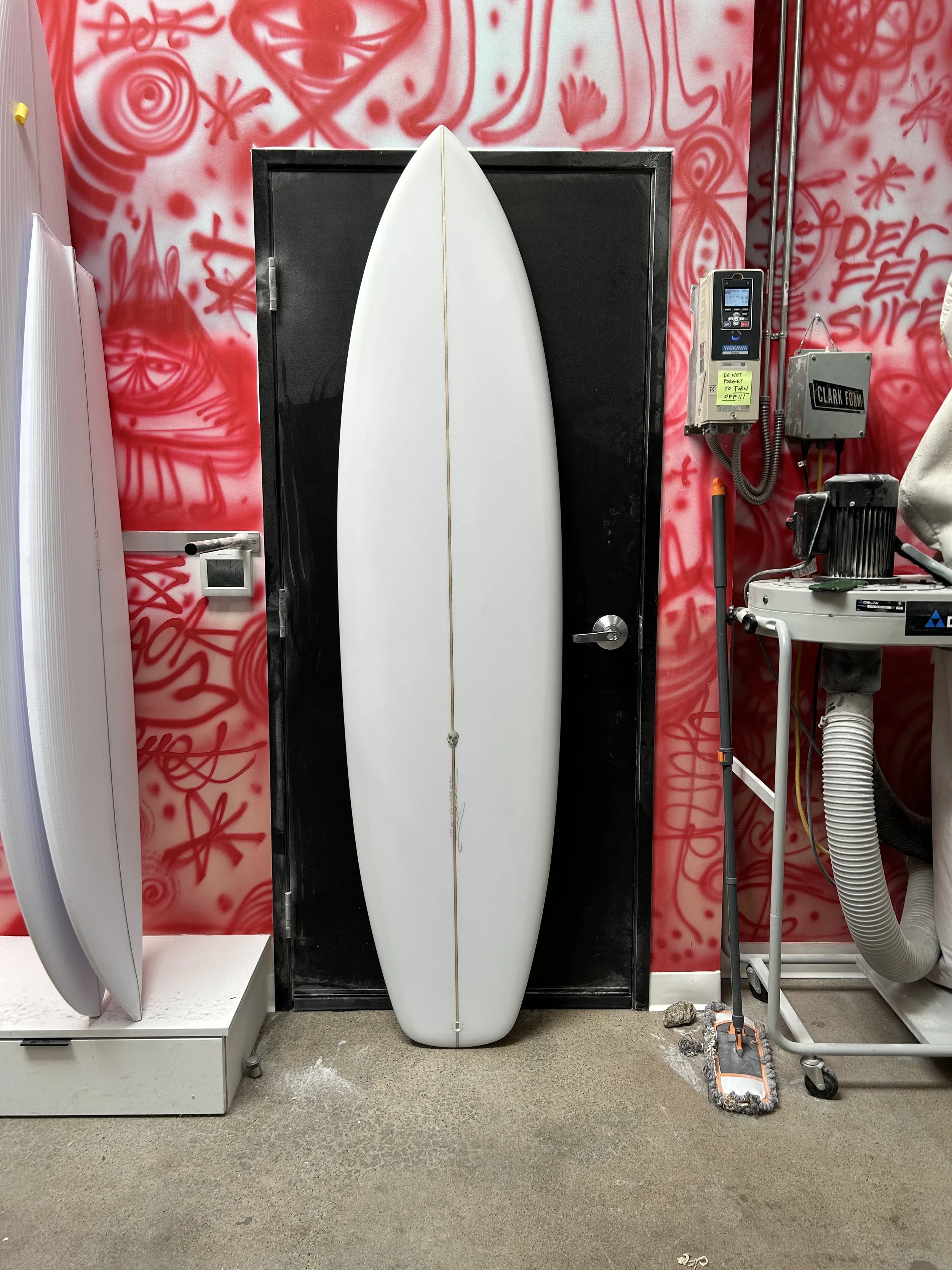 surfboard against a black door