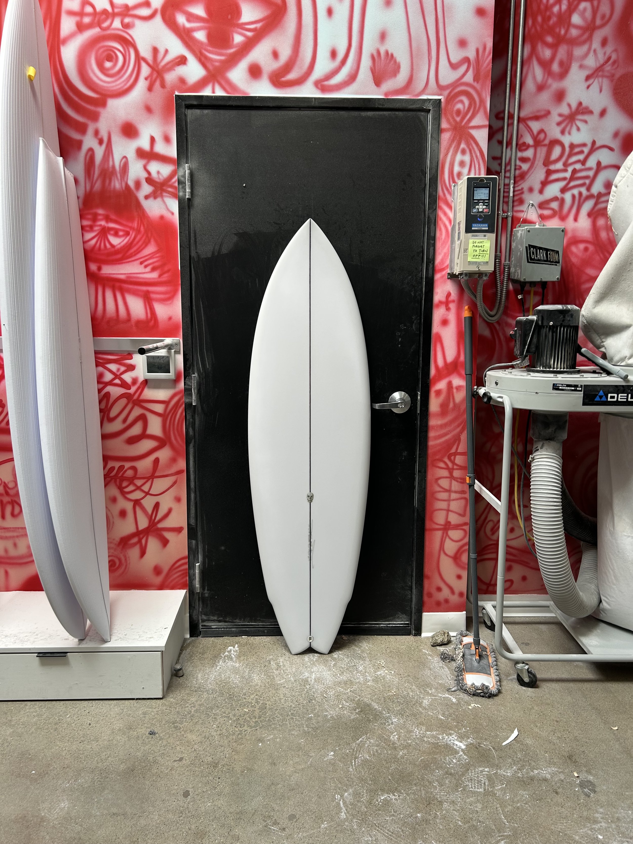 lane splitter surfboard against a black door