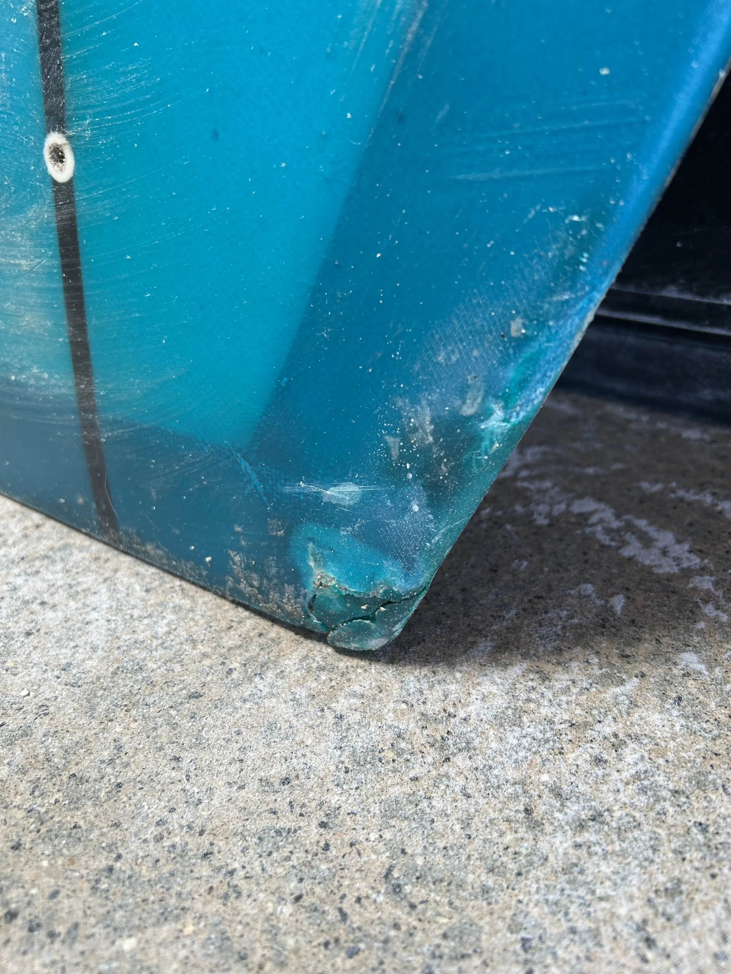 tail damage on blue surfboard