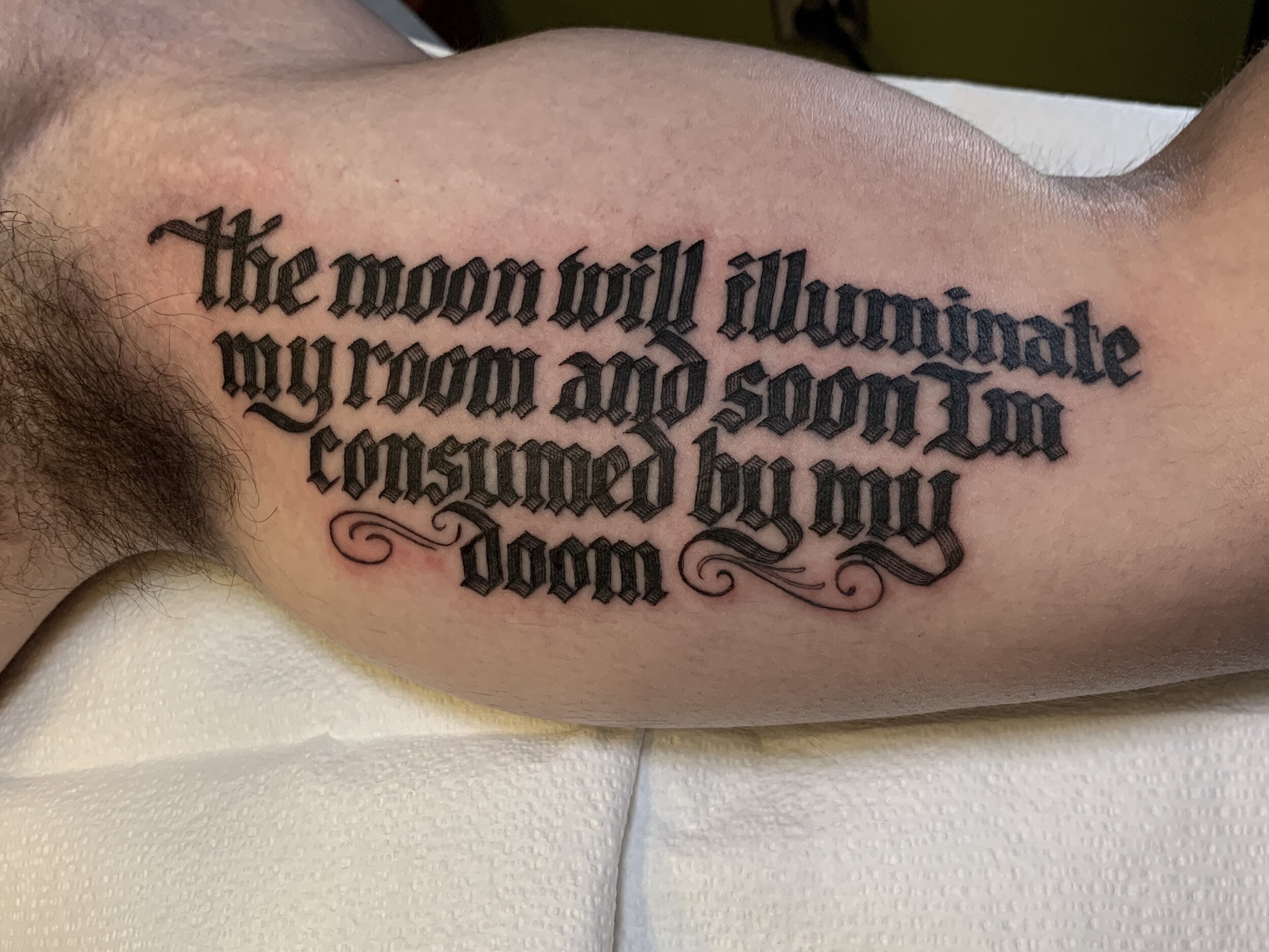  Bicep script lettering tattoo with Kid Cudi lyrics to "Soundtrack 2 My Life" 
