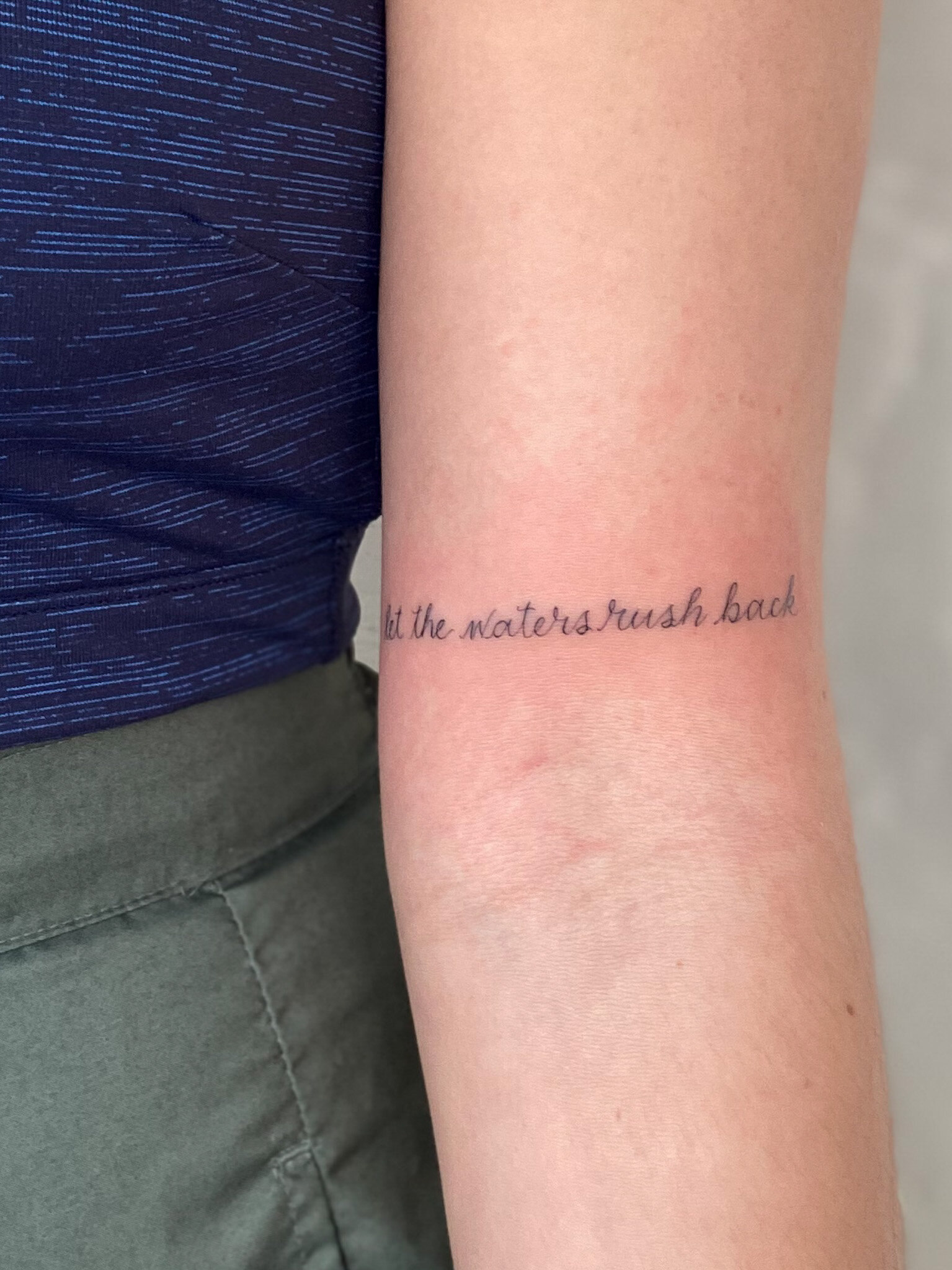  "Let the waters rush back." script tattoo 