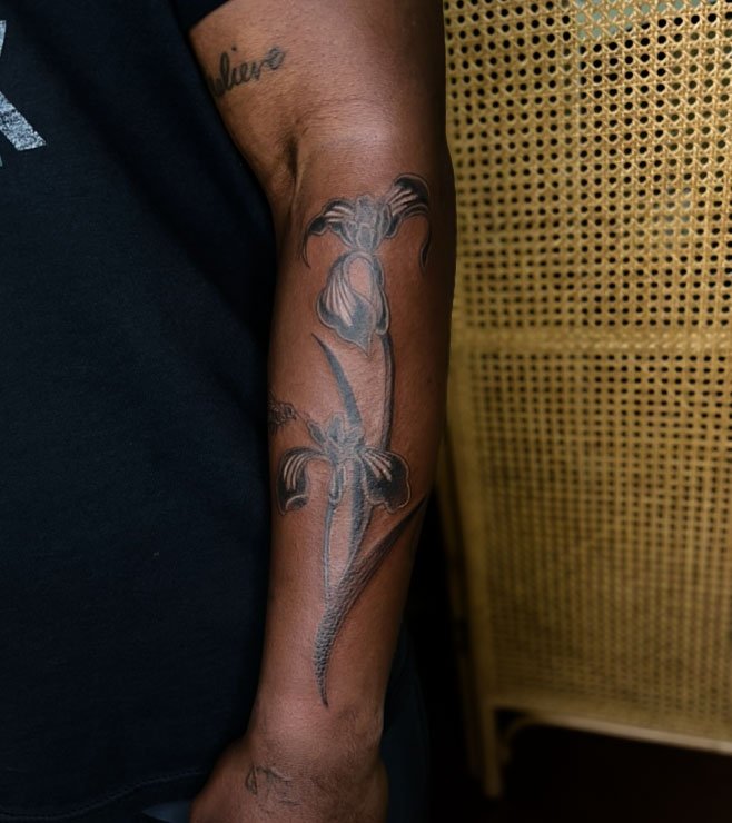  tattoo inspired by vintage 80s ceramics. using high contrast and swooping shapes this tattoo hugs the curve of the person's arm. Tattoo is located on the front of a forearm of a man with deep rich skin tone. Best Georgetown Texas tattoo dark skin to