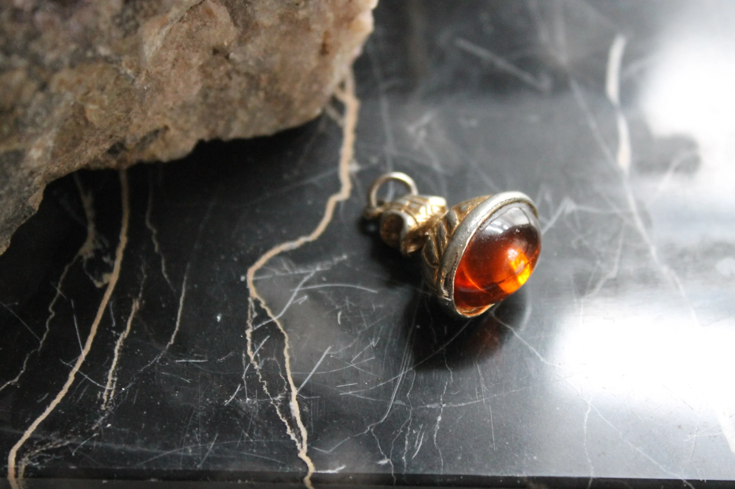 Oval amber colored charm